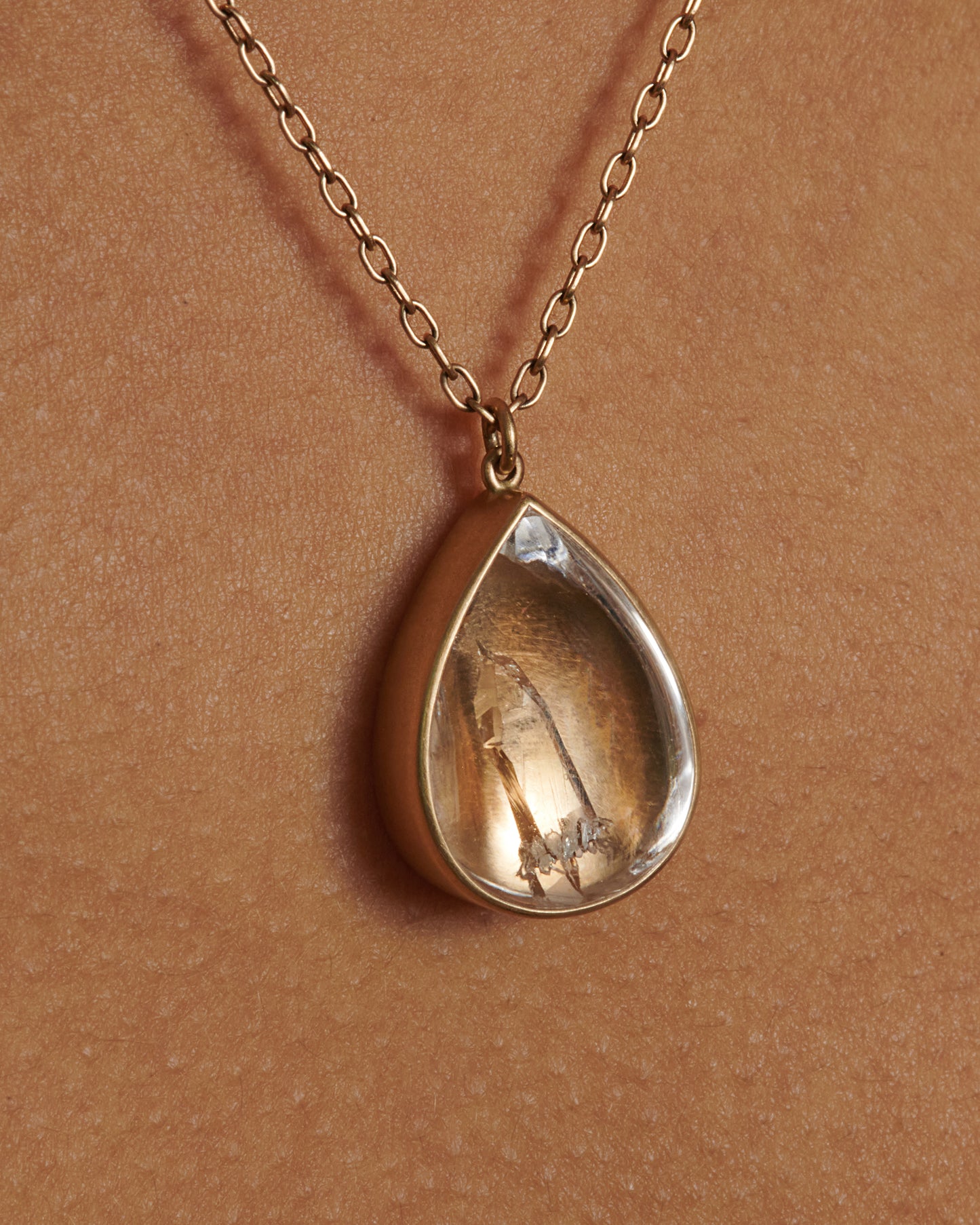 A quartz crystal teardrop pendant sitting on a fine 18k yellow gold chain. We love this piece for its stunning simplicity, making it a perfect daily staple that can be easily layered with alongside mixed metals and different stones.