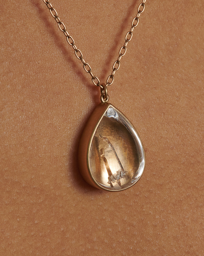 Lola Brooks necklace in yellow gold, a clear quartz crystal teardrop with an inclusion inside, in a gold bezel on a chain