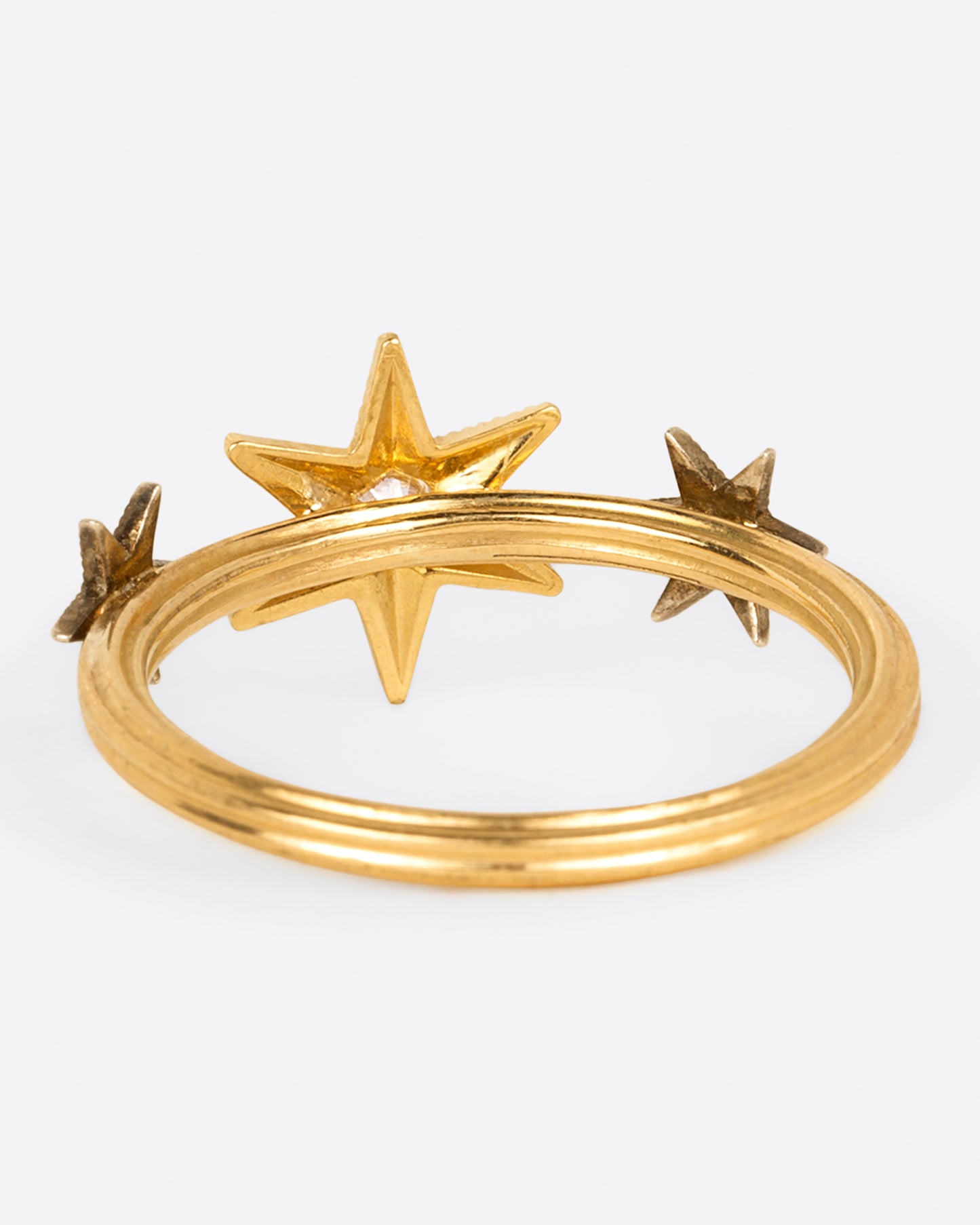 This ring features three millgrain stars; two platinum and one yellow gold, all dotted with diamonds.