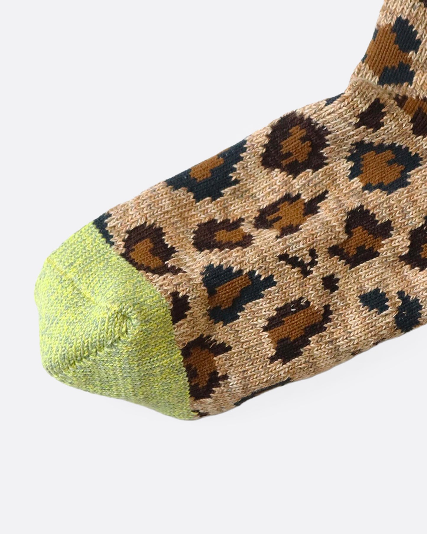 A leopard print ankle sock with a green toe, shown from the side.