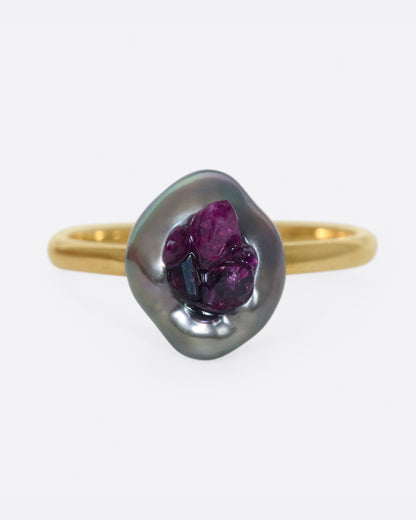 Yellow gold freshwater pearl ring lined with reclaimed rubies. View from the front.