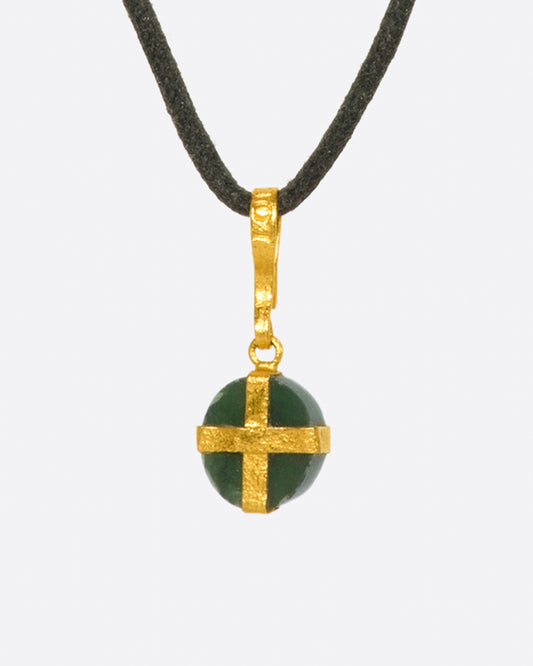 A forest green bloodstone wrapped in 22k gold on an adjustable black cord with a sliding stone closure.