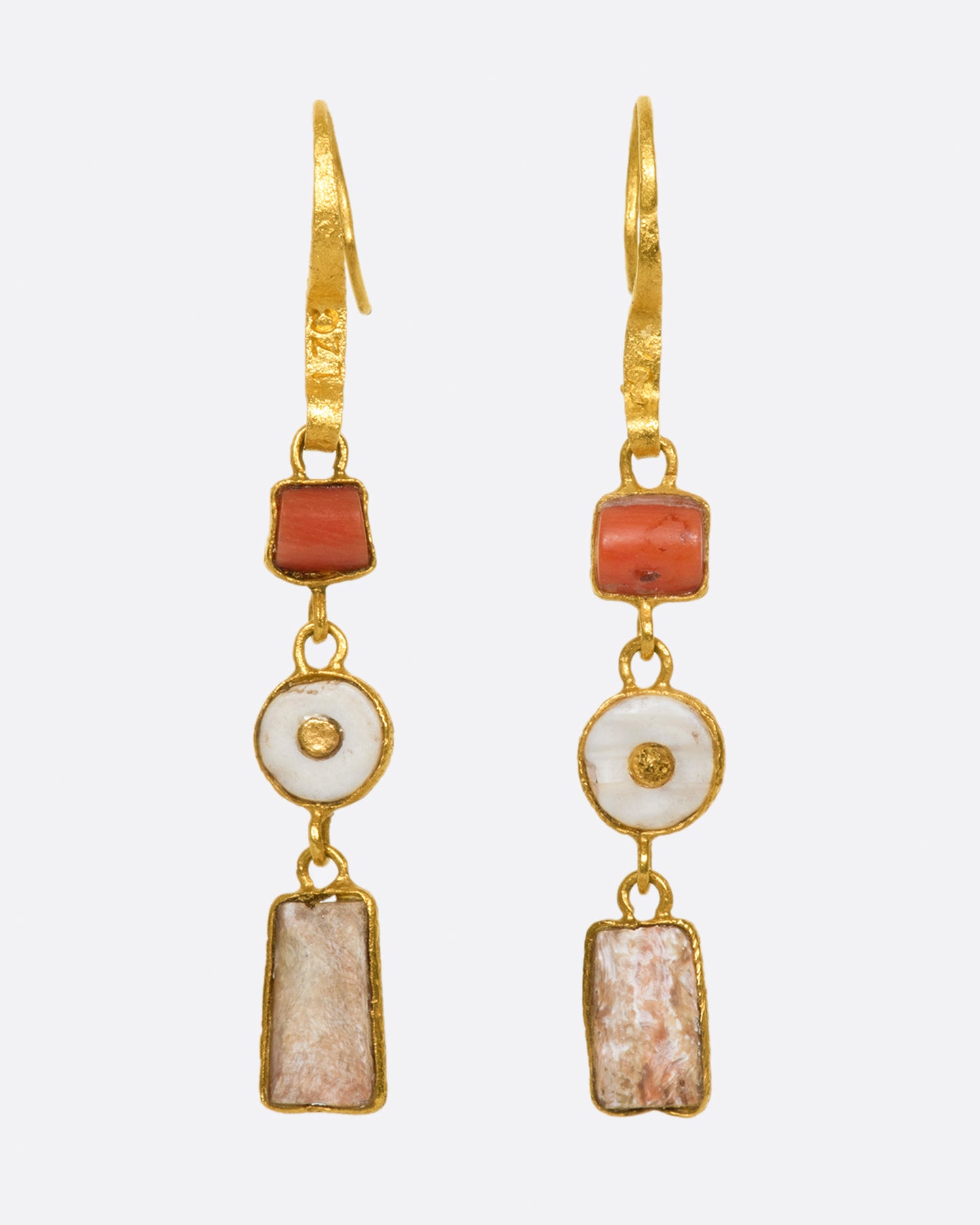 A pair of high karat gold triple drop earrings with coral and clay fragments