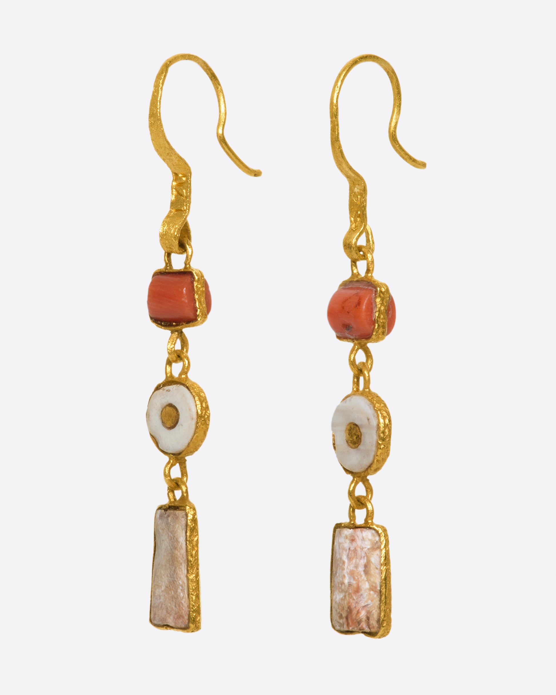 A pair of high karat gold triple drop earrings with coral and clay fragments