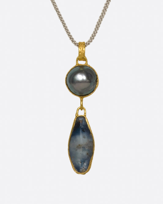 A gold-wrapped double drop pendant with Tahitian pearl and Sri Lankan sapphire. Somehow exotic and classic at the same time.