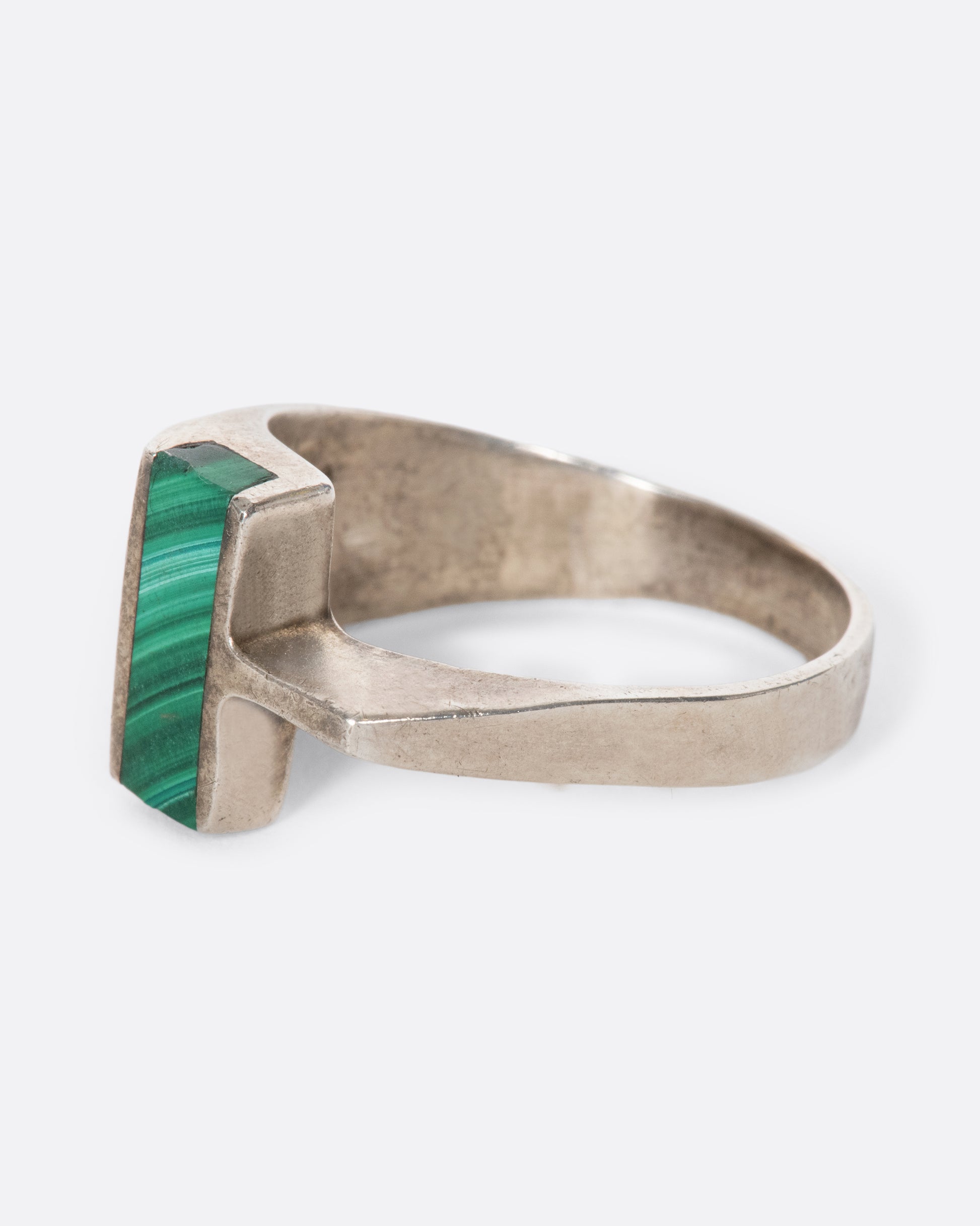 A vintage sterling silver T-shaped ring with a slice of malachite sitting high above your finger. The interesting asymmetry makes a statement without sacrificing comfort.