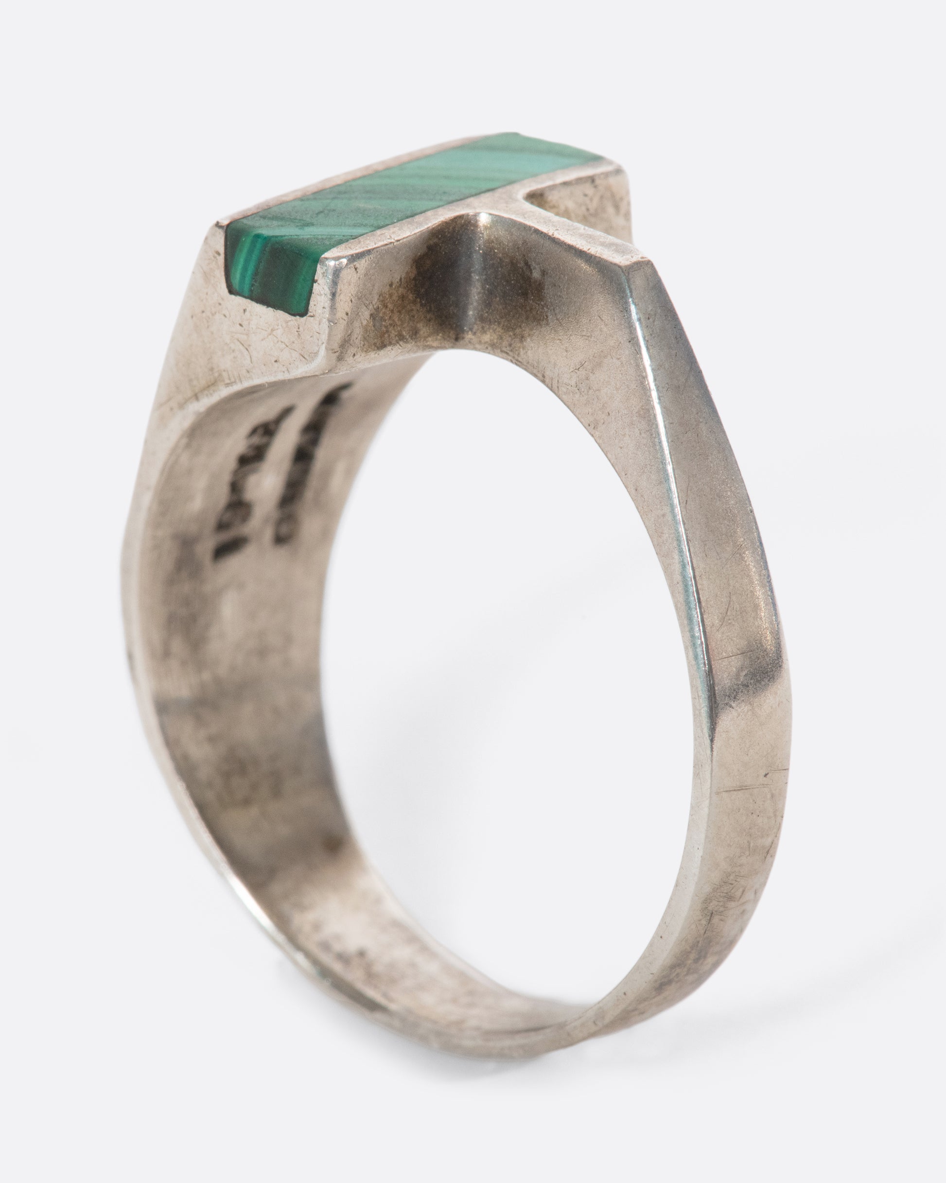 A vintage sterling silver T-shaped ring with a slice of malachite sitting high above your finger. The interesting asymmetry makes a statement without sacrificing comfort.