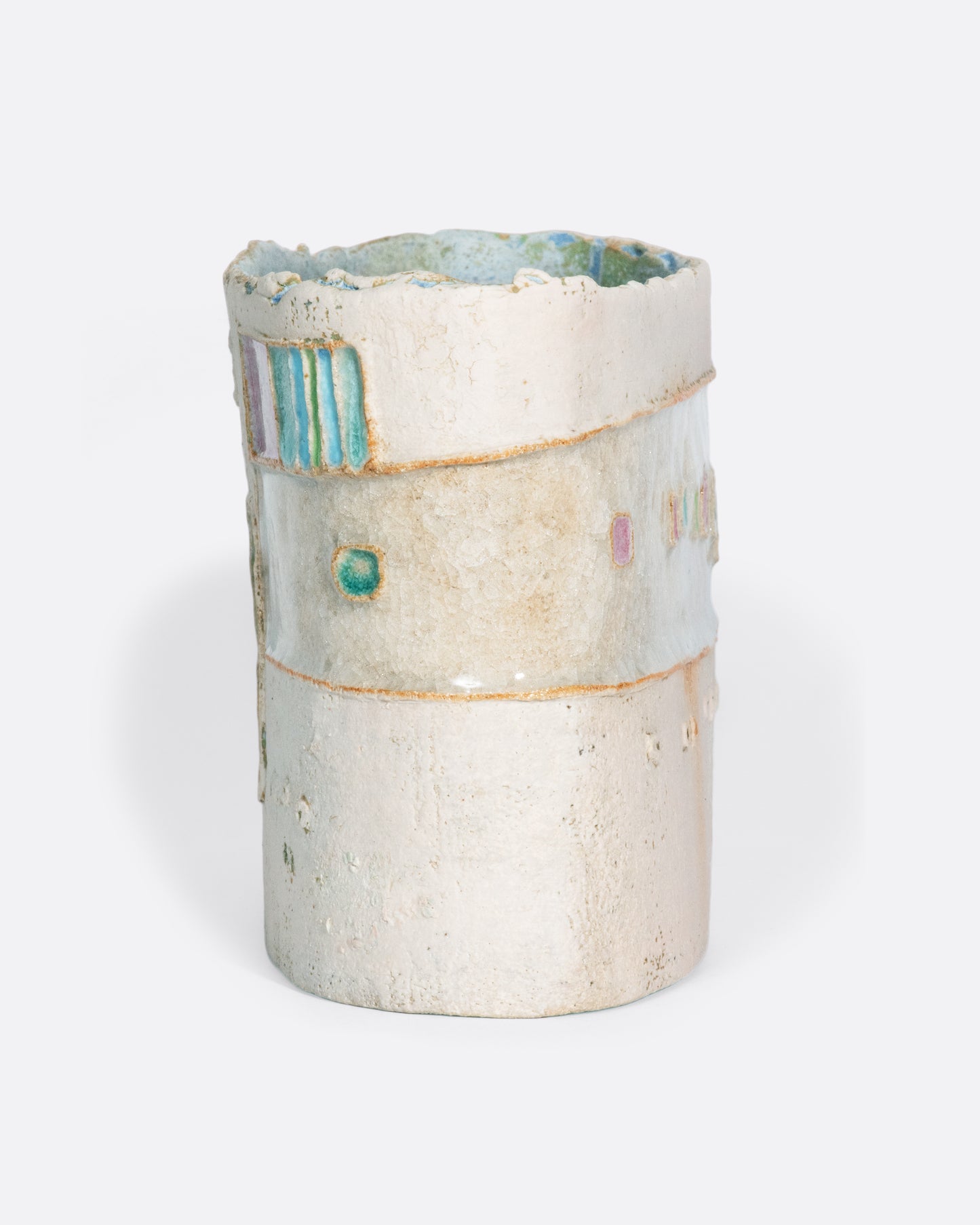 A ceramic vessel meticulously handmade with many layers of glaze atop stoneware clay. The rich, varied texture becomes a beautiful canvas for a dreamy slice of a sun-drenched town in Greece.