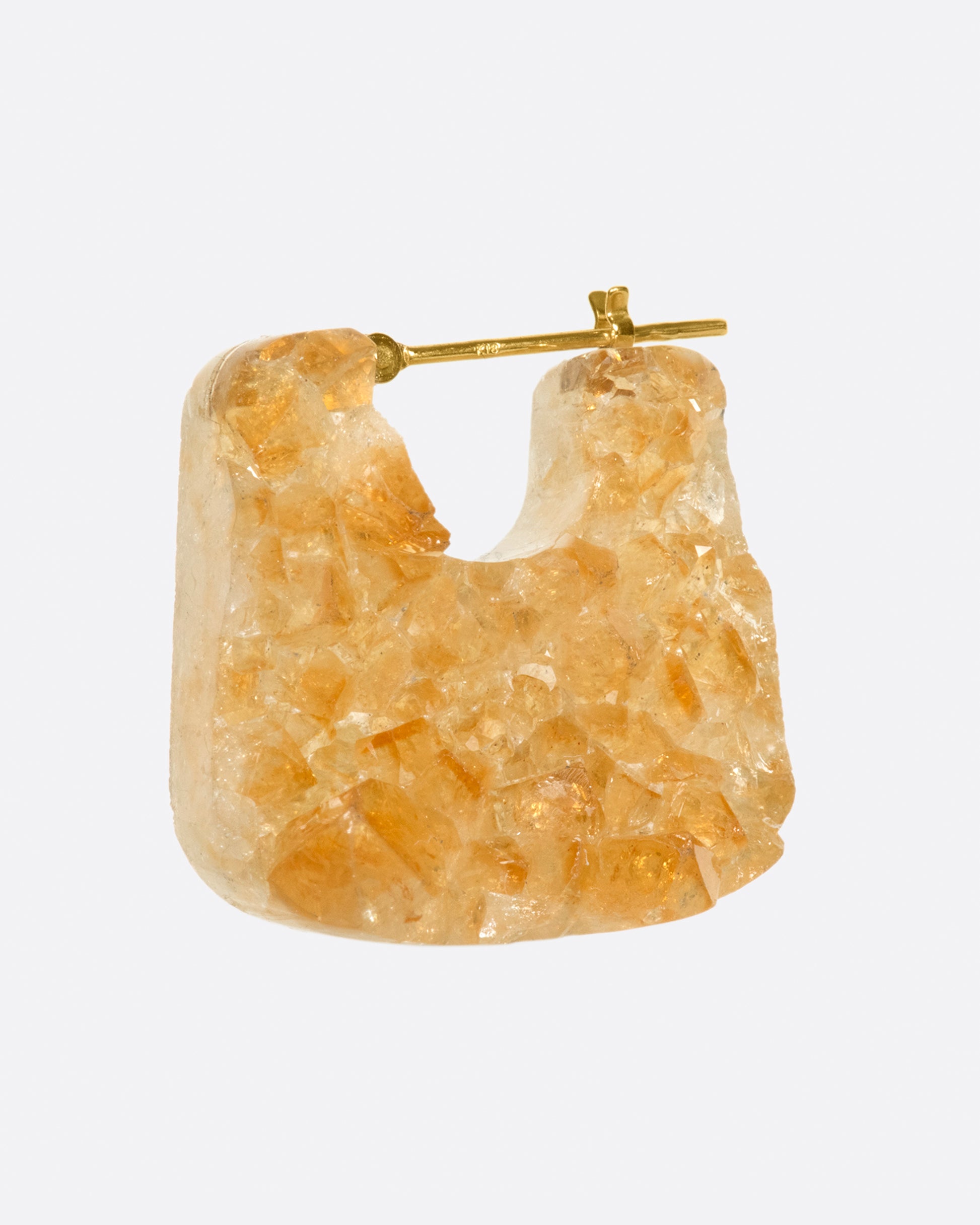 The shape of this earring celebrates the raw natural stone.