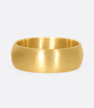 A solid, heavy gold ring with a satin finish.