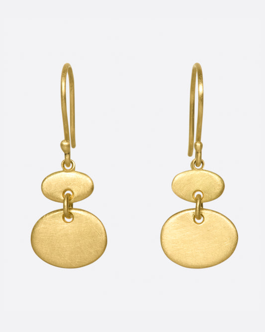 A pair of matte gold sequin earrings with great movement.