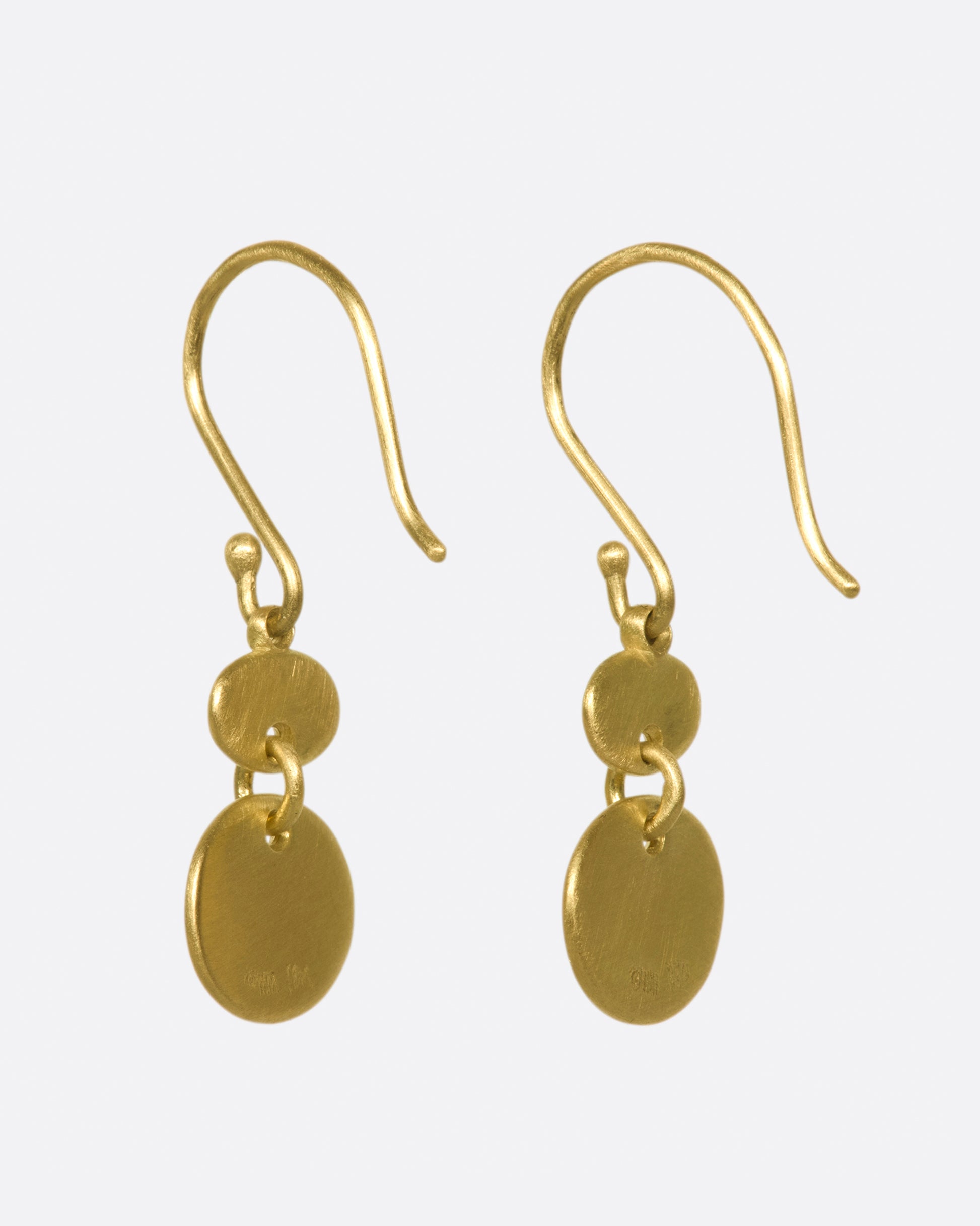 A pair of matte gold sequin earrings with great movement.