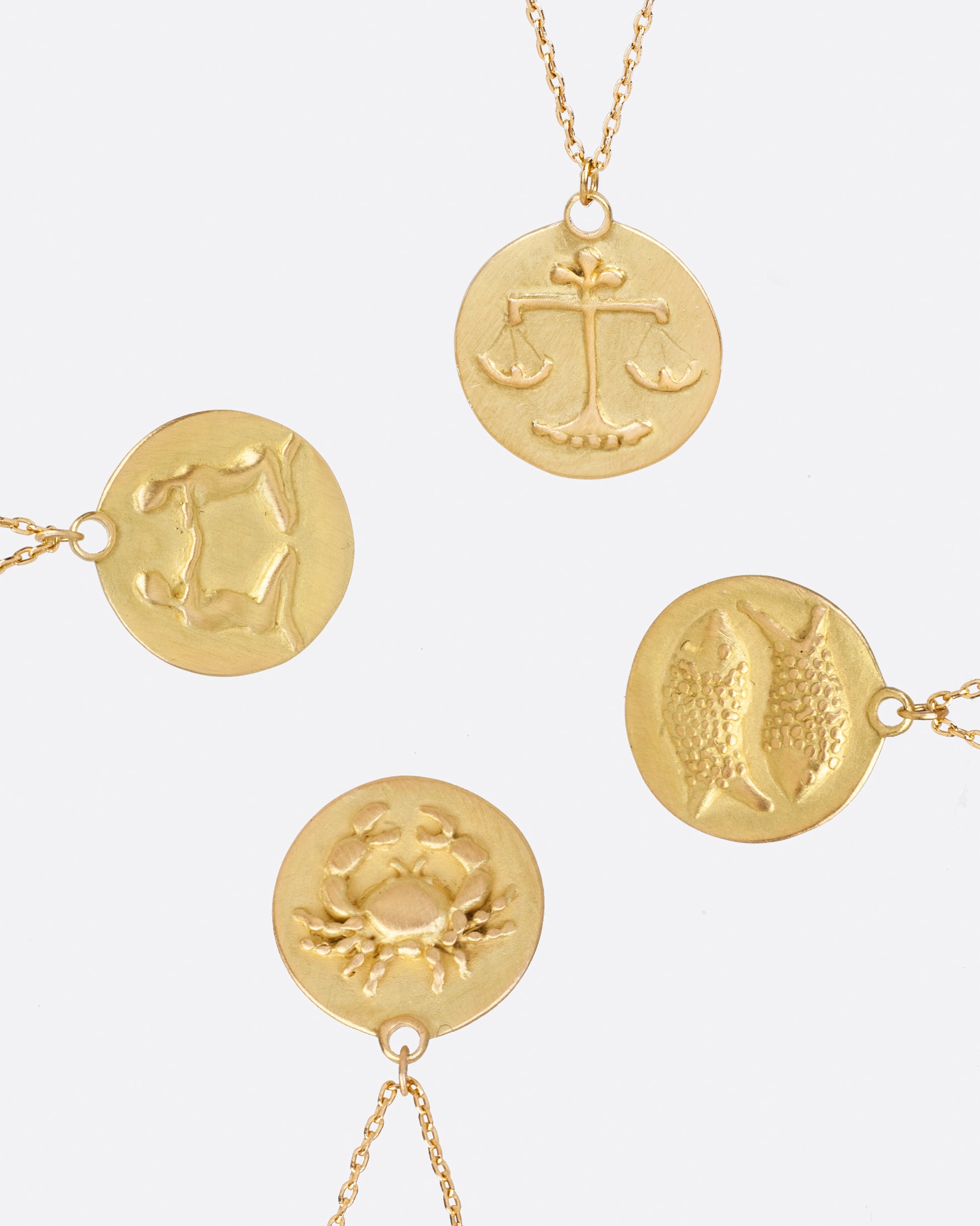 Each of these disc pendants features a hand carved and cast astrological symbol. With an ancient style design, these medallions are timeless and classic