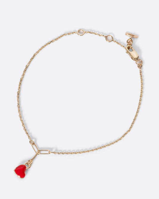 A precious candy apple red enamel heart on a fine gold chain bracelet