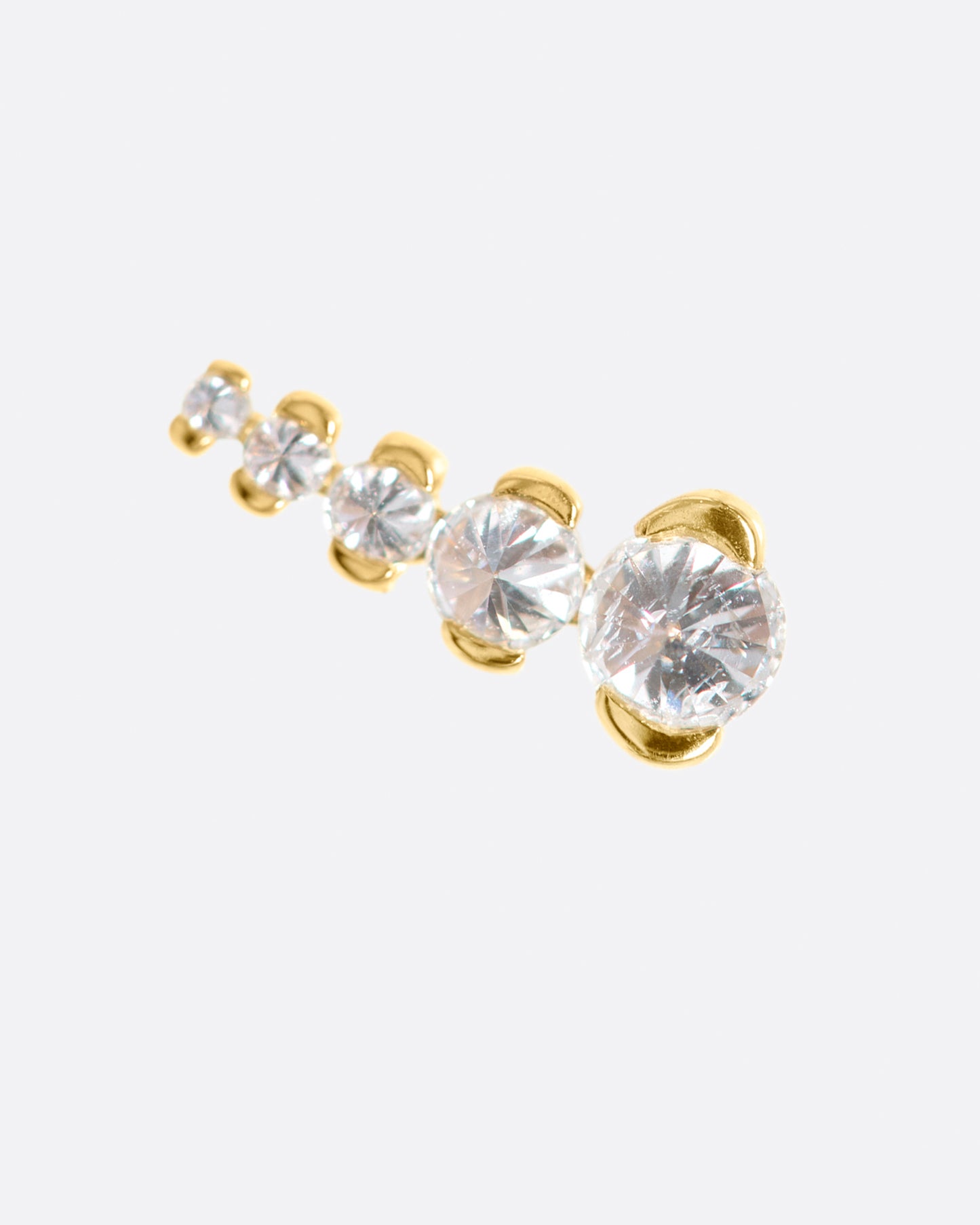 A gold stud with five inverted diamonds arranged in a slight curve.