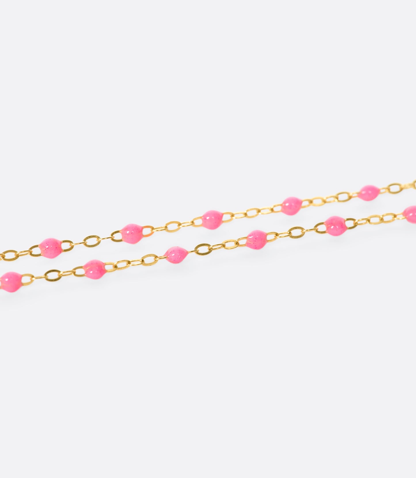 A thin rose gold chain necklace with resin beads. Each necklace is hand dipped in melted resin to create the beaded effect. 