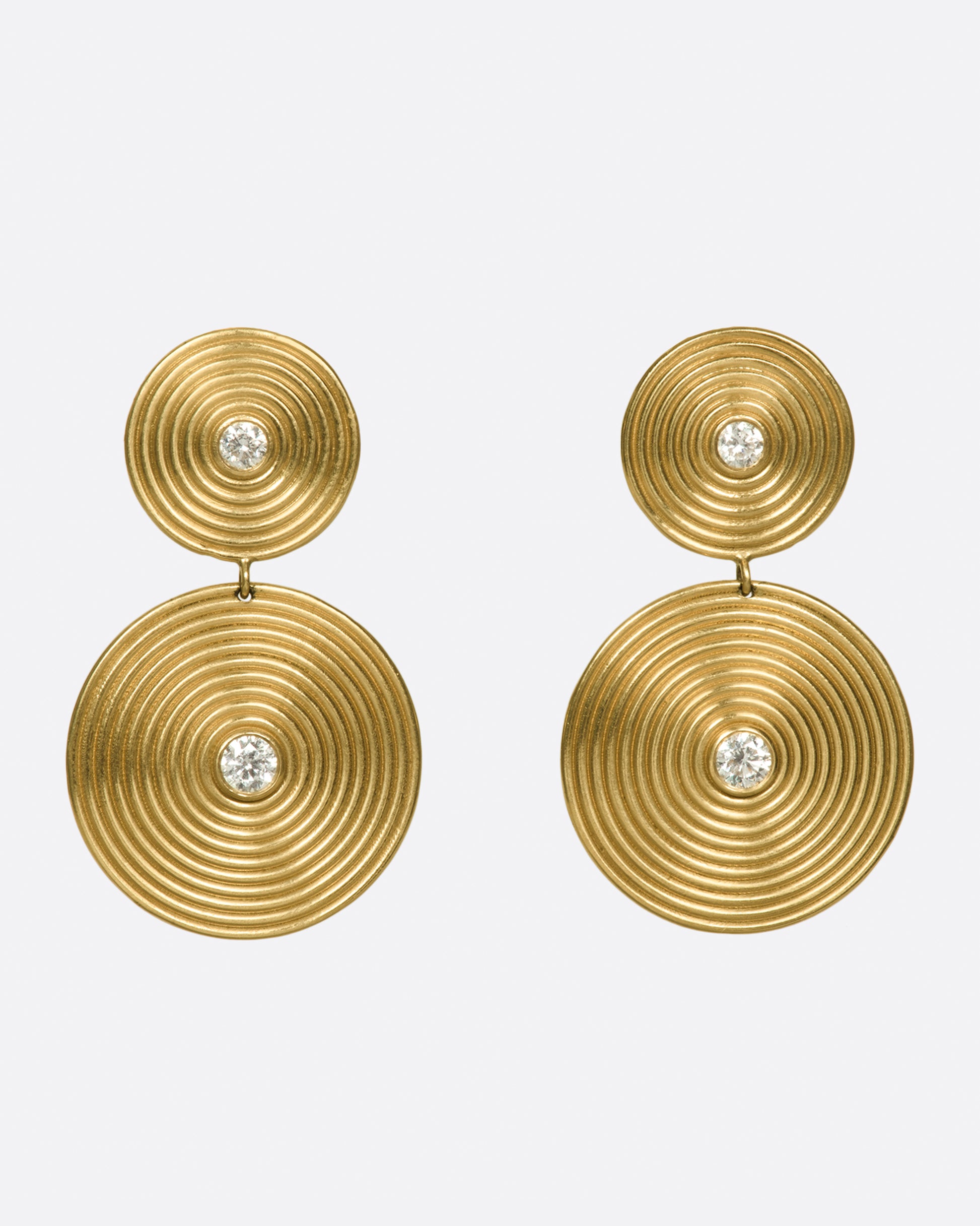 14k gold disc drops, each punctuated with two white diamonds. The concentric circles are elegant symbols of growth and change.