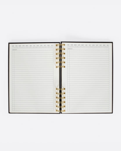 Black spiral notebook, open to lined pages