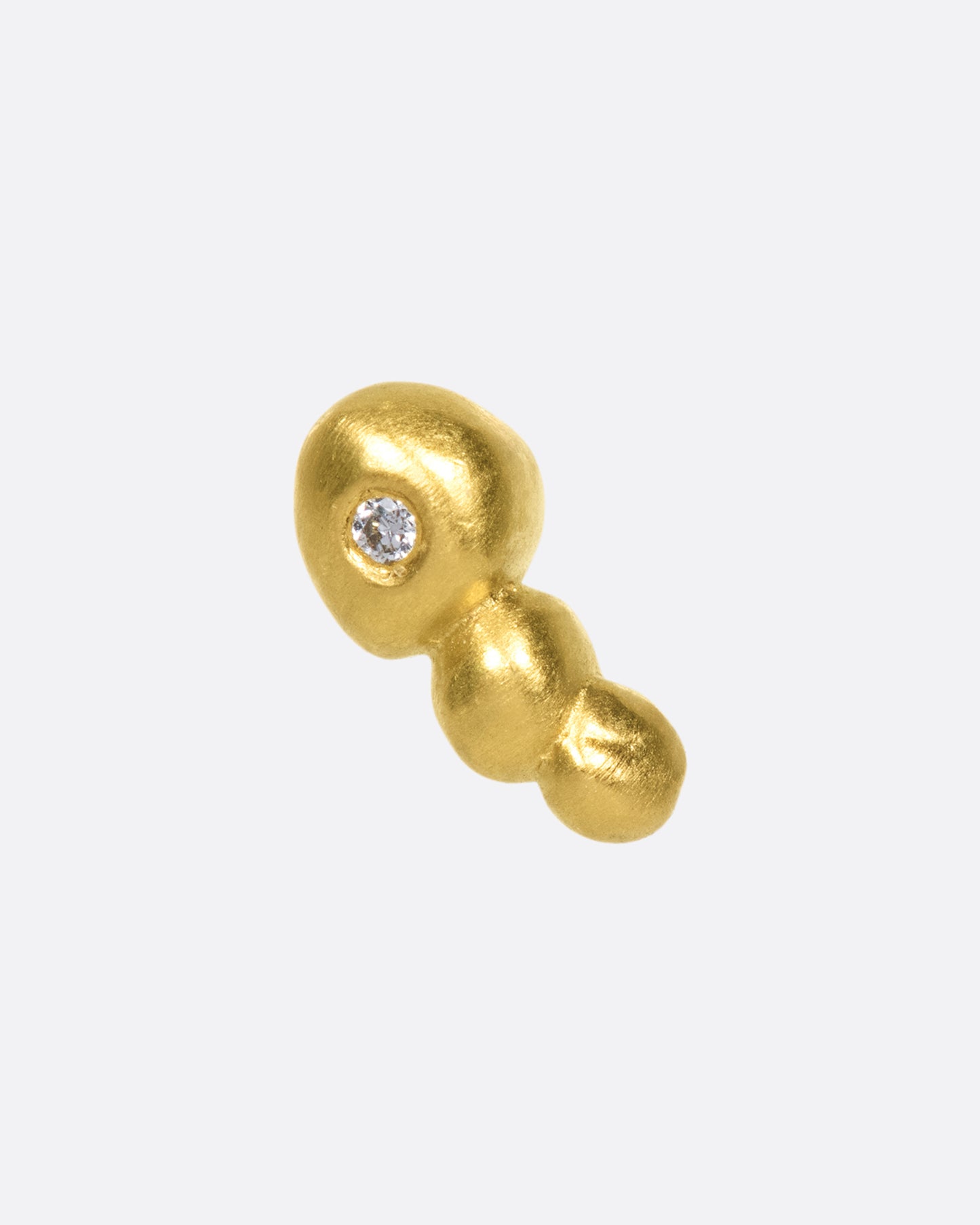 This high karat gold stud is perfect to tuck into little curves in the ear.