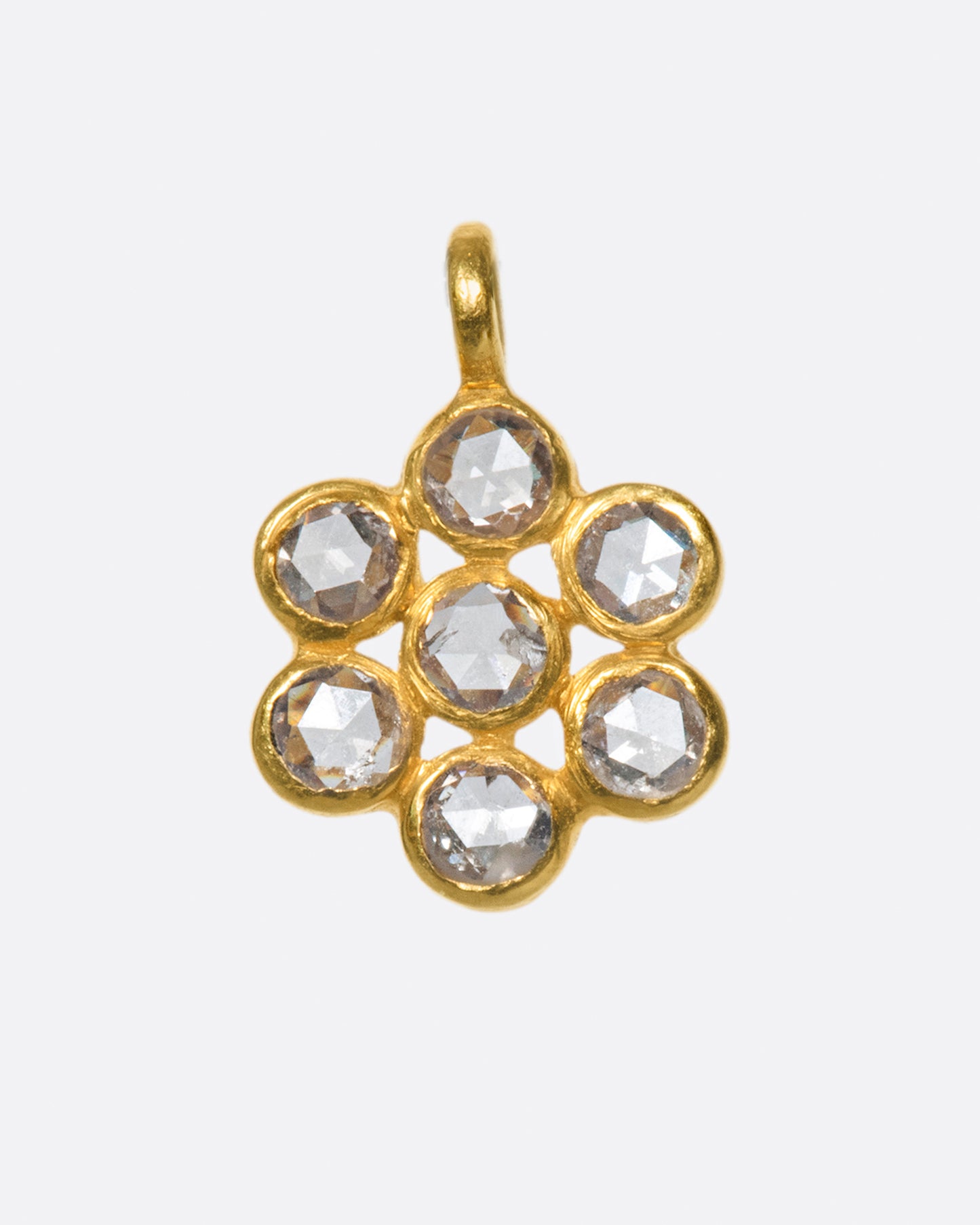 A cluster of round rose cut diamonds set in one of the simplest floral design.