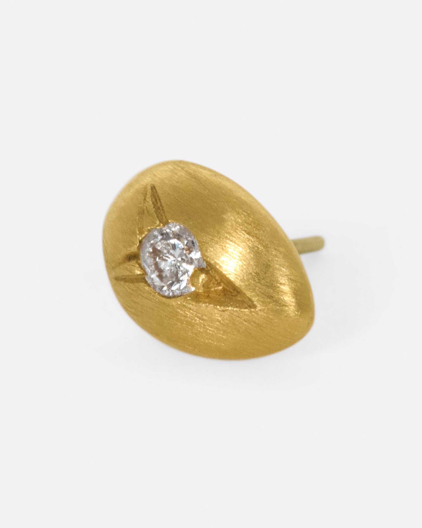This brushed gold earring is smooth and rounded like a real drop of water.