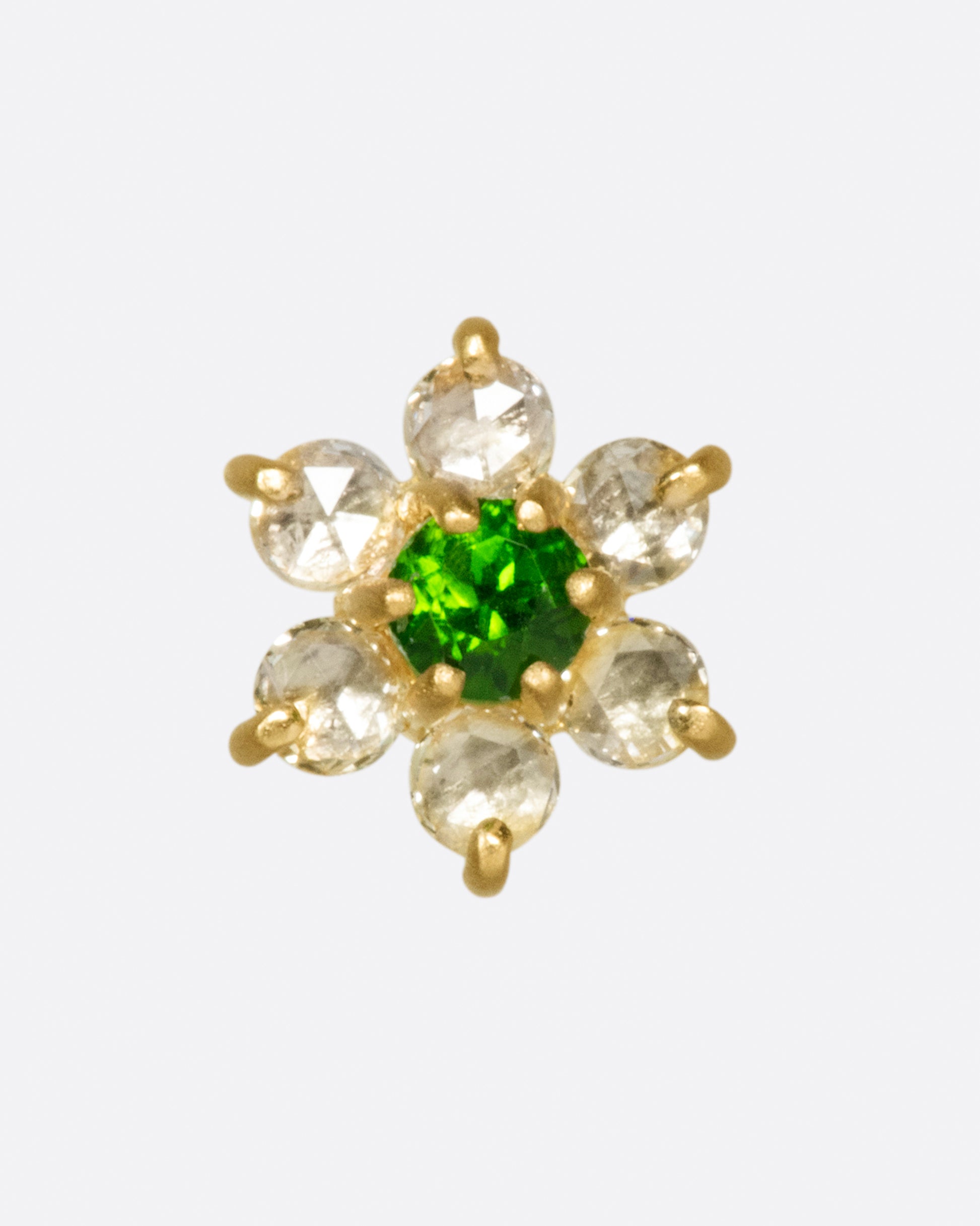 A yellow gold threadless earring front made from 6 white diamond and one green chrome diopside in the shape of a flower.