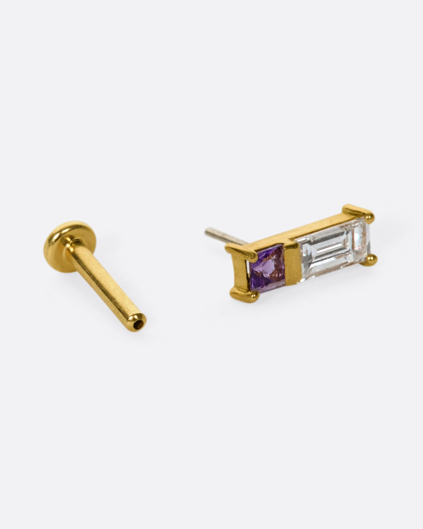 A play on color and geometry, this stud is made up of a princess cut amethyst and a baguette diamond.