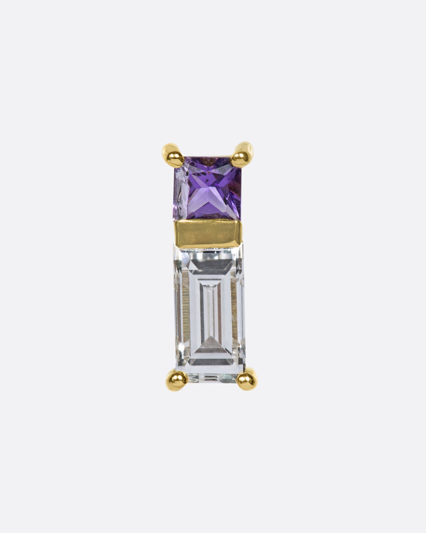 A play on color and geometry, this stud is made up of a princess cut amethyst and a baguette diamond.