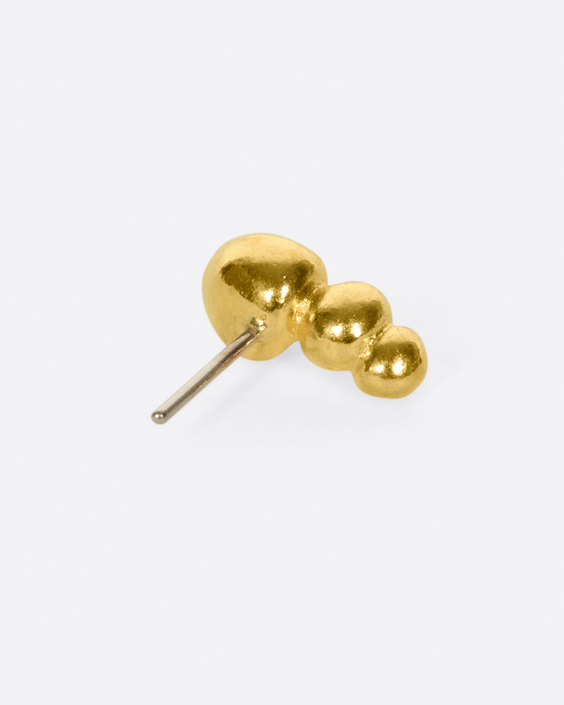 Three granules of bright, high karat gold to add some texture to your ear.