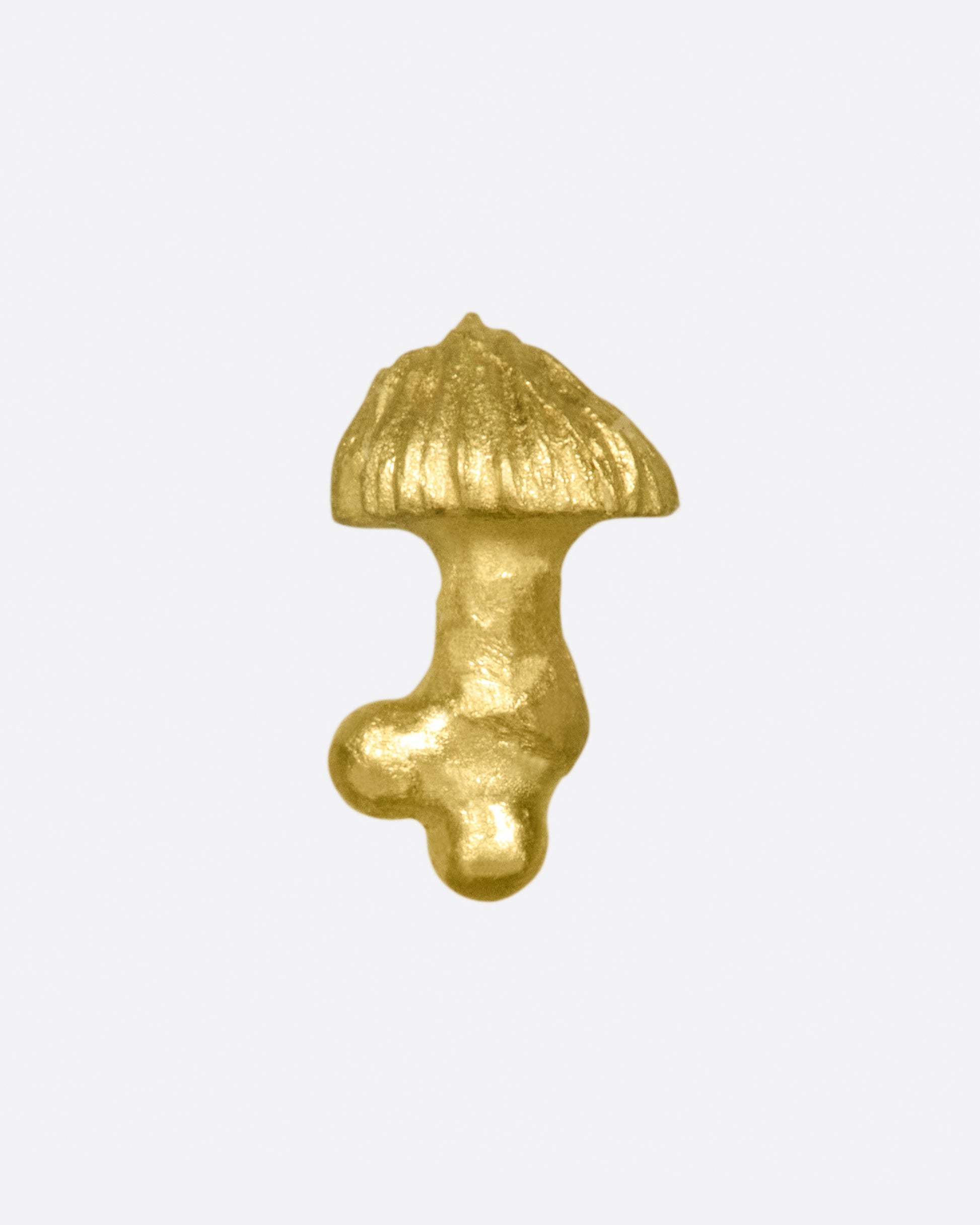 A small, matte gold, hand carved mushroom.