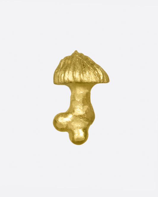 A small, matte gold, hand carved mushroom.