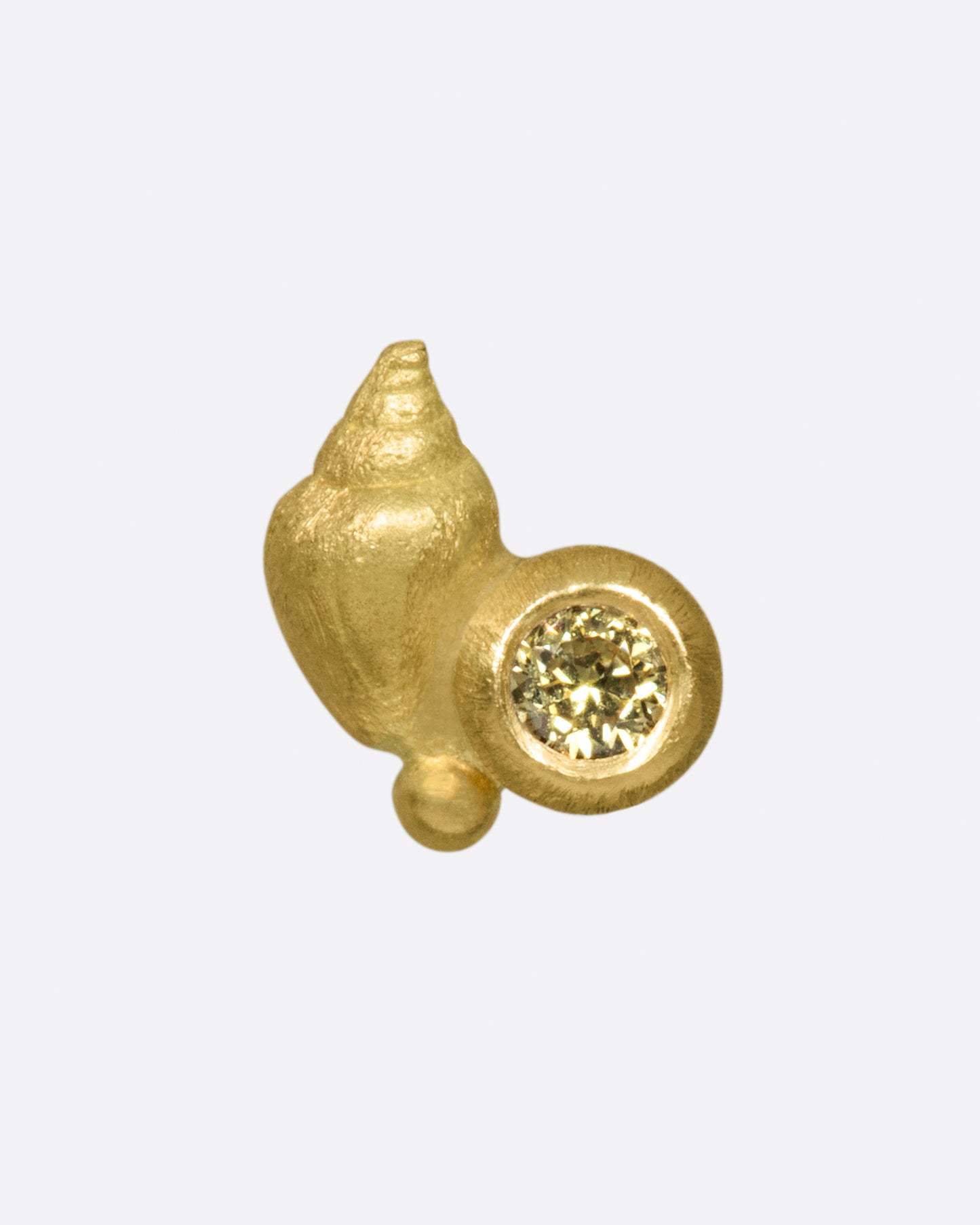 A matte gold sea shell accented by a pale yellow diamond.