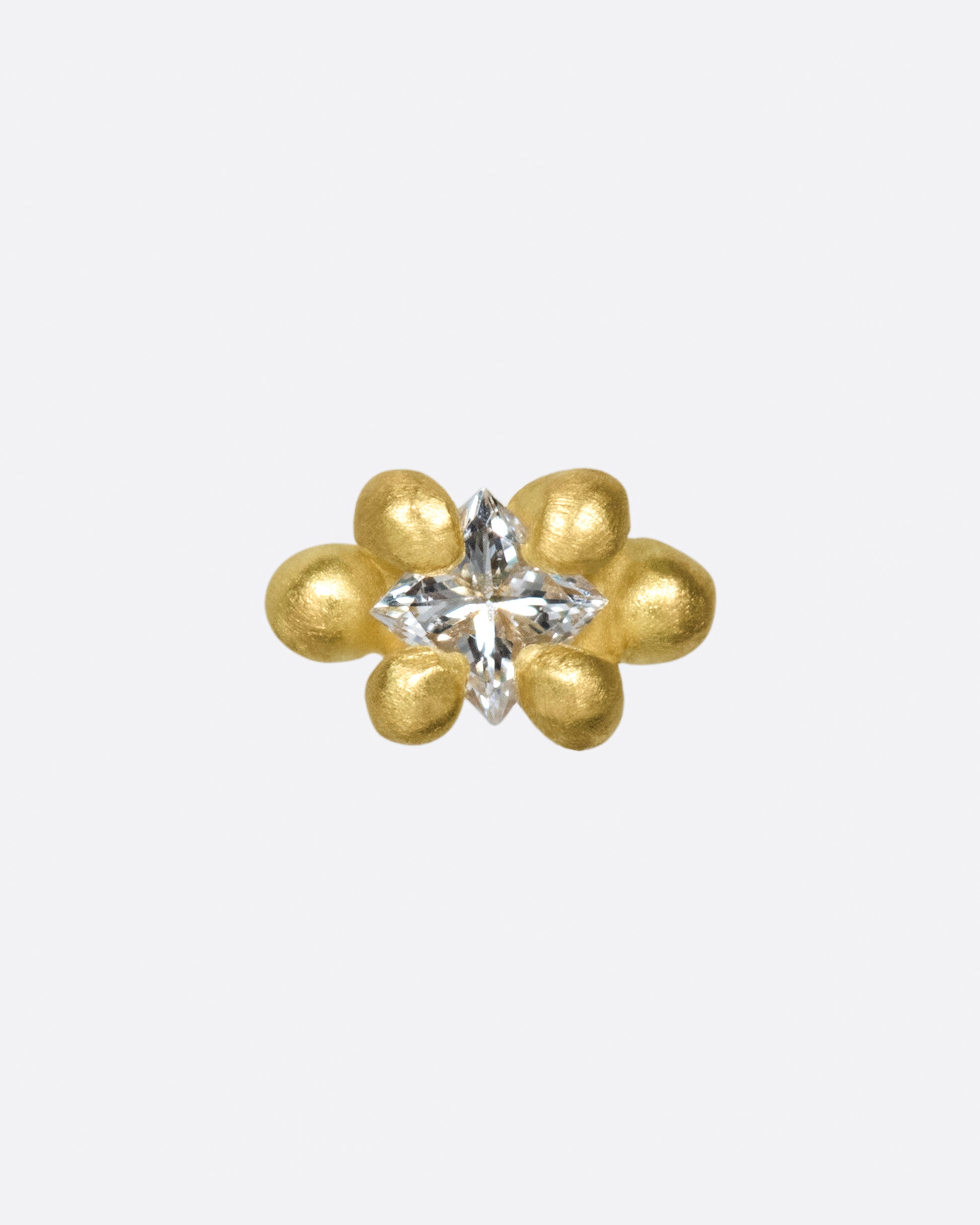 This solitaire stud's matte gold prongs make it more substantial, while remaining soft looking.