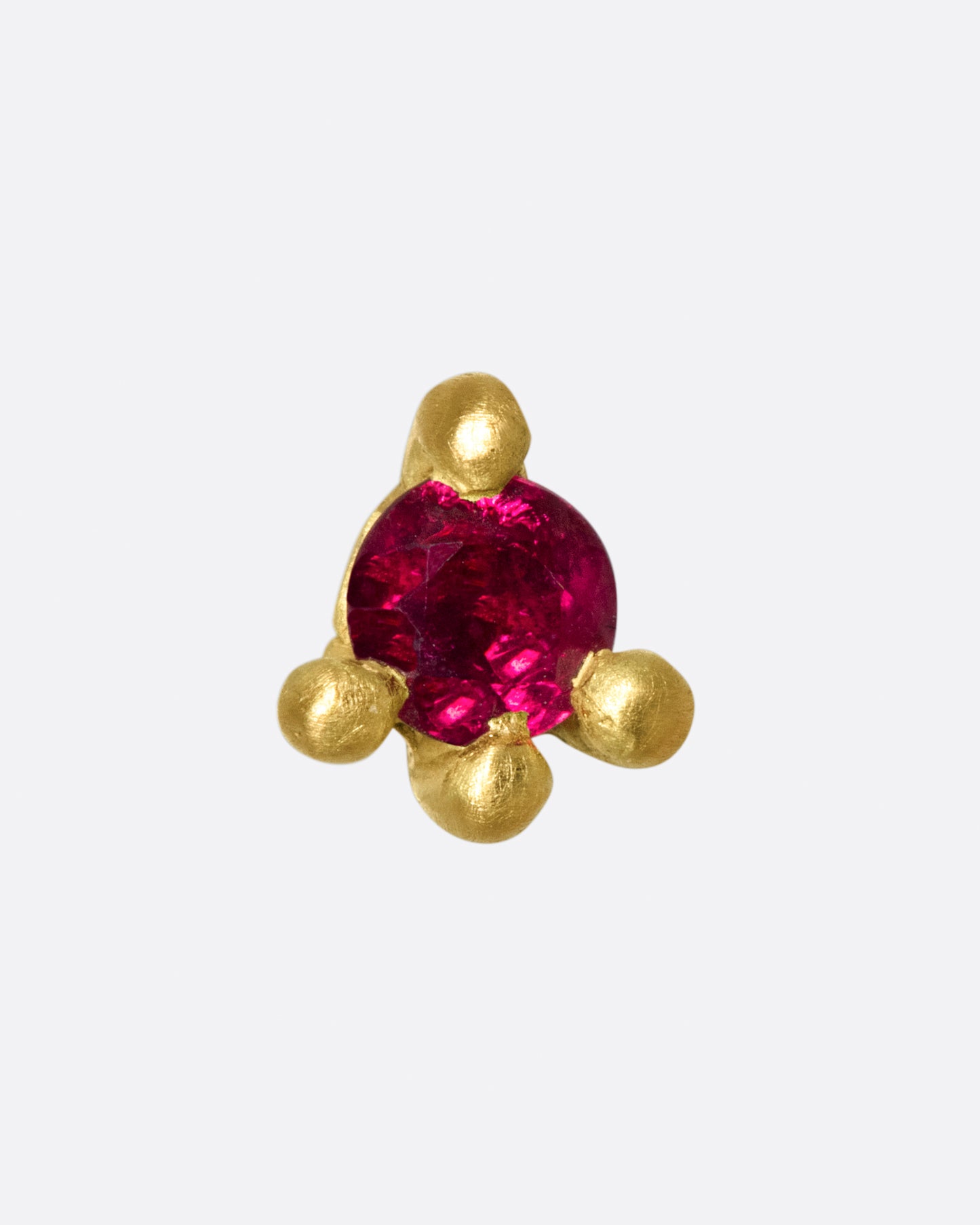 This earring is really about the ruby; large and saturated, it's a statement in itself.