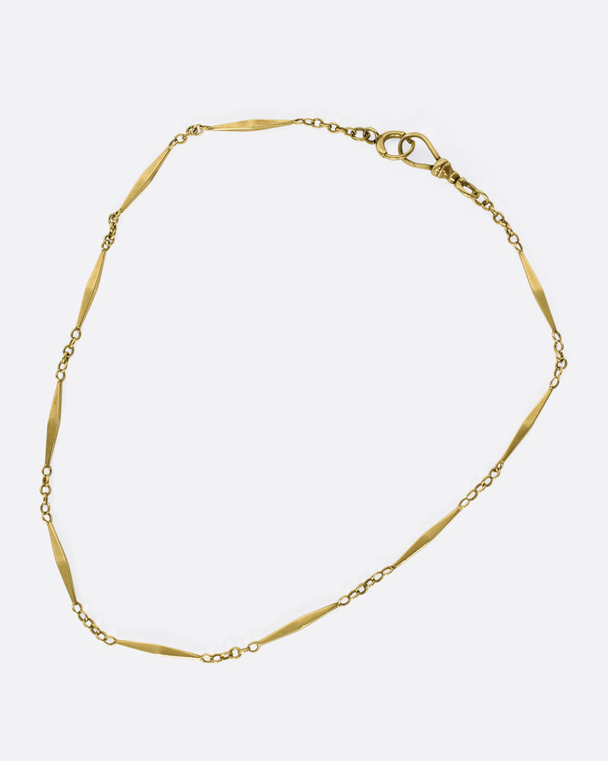This necklace is choker length and comprised of alternating handcrafted octahedron links and cable link stations; the clasp is perfect for attaching your favorite charms.
