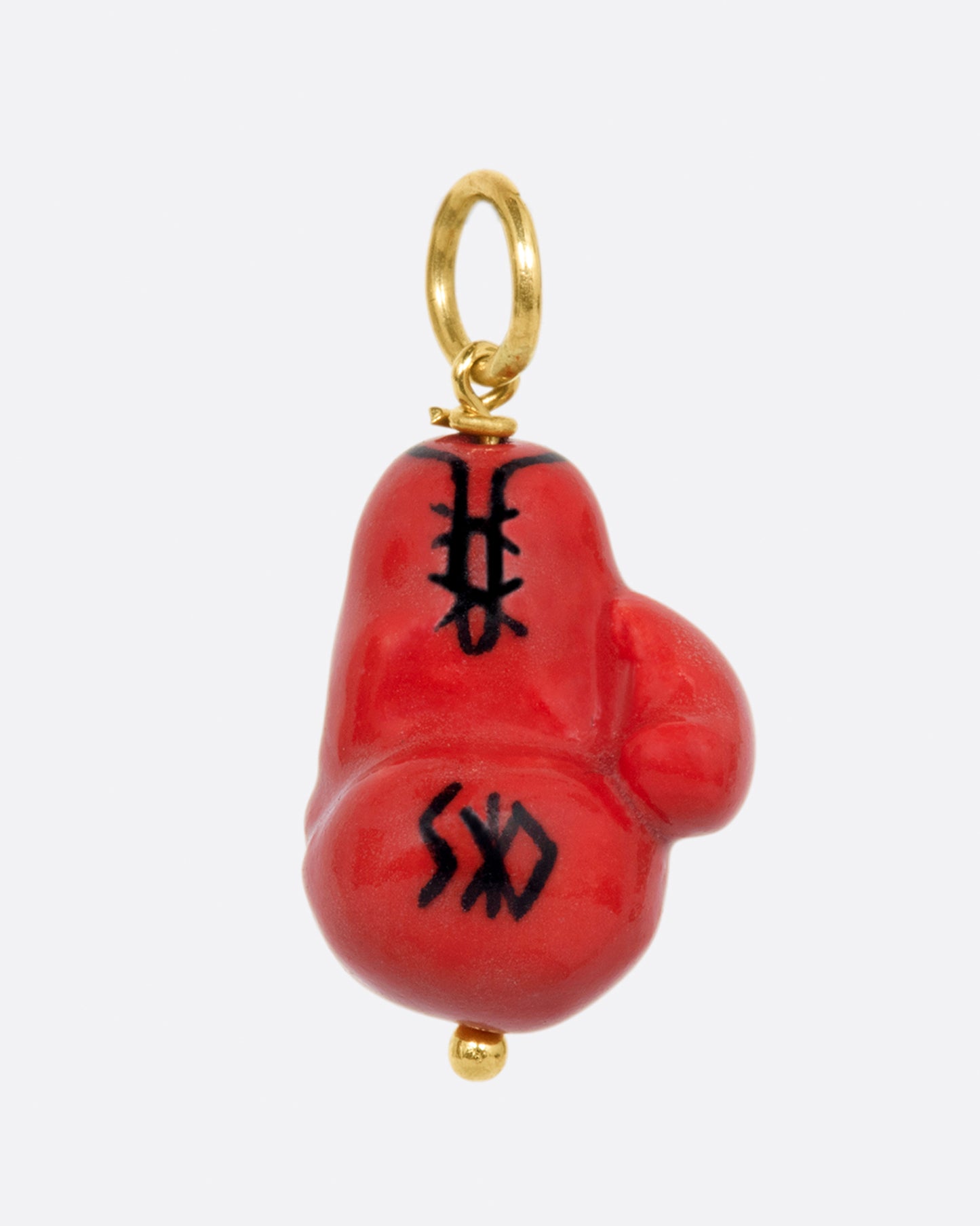 A handmade porcelain red Everlasting boxing glove charm with the words "Knock out" written on it, with a yellow gold bail.