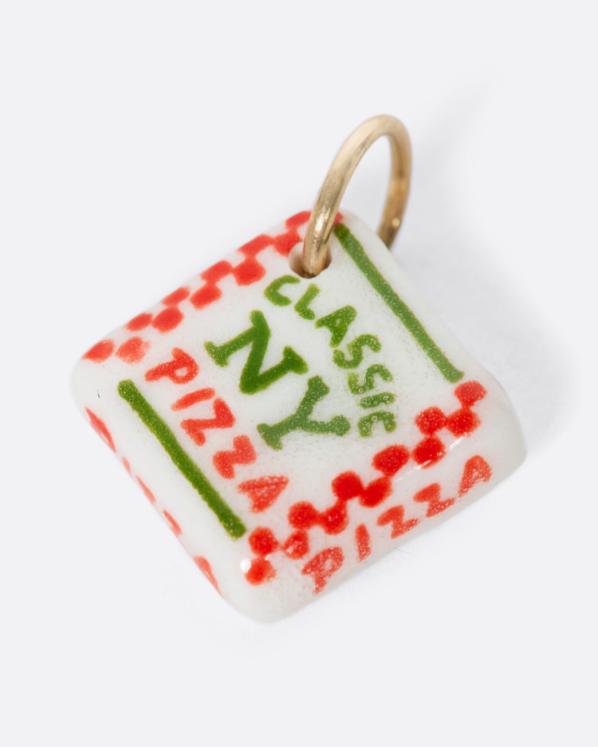 A white porcelain Classic New York pizza box charm with a yellow gold bail