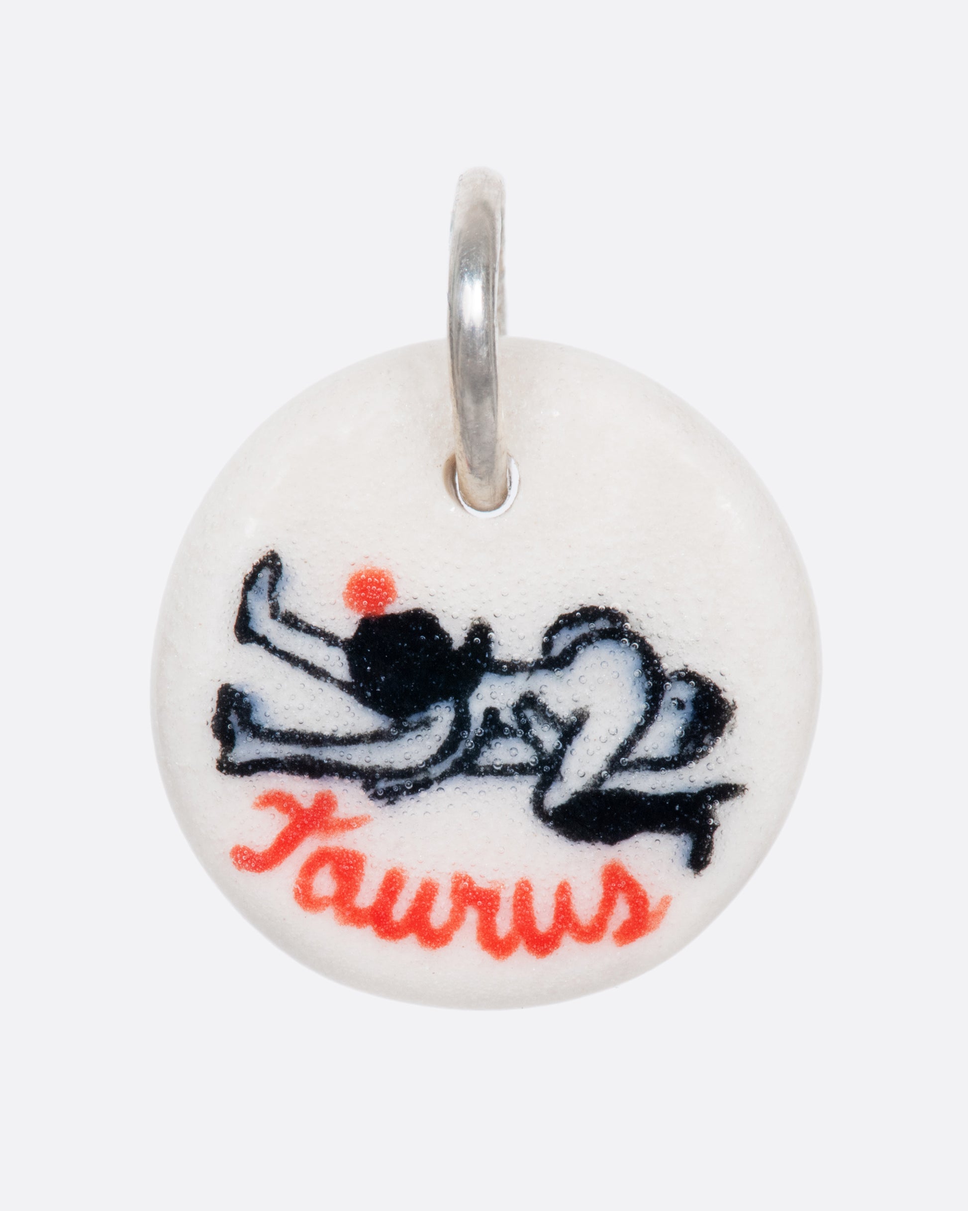 A handmade and painted porcelain zodiac disc charm with a sterling silver bail, featuring a sex position specific to each zodiac.