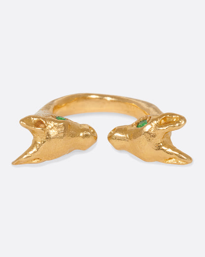Yellow gold animal head ring with emerald eyes, top view of the heads with their pointed ears and emerald eyes