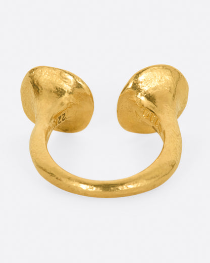 A high karat gold open ring with a large organic shaped disc on each end with a rosey pink tourmaline at its center. Shown from the back.