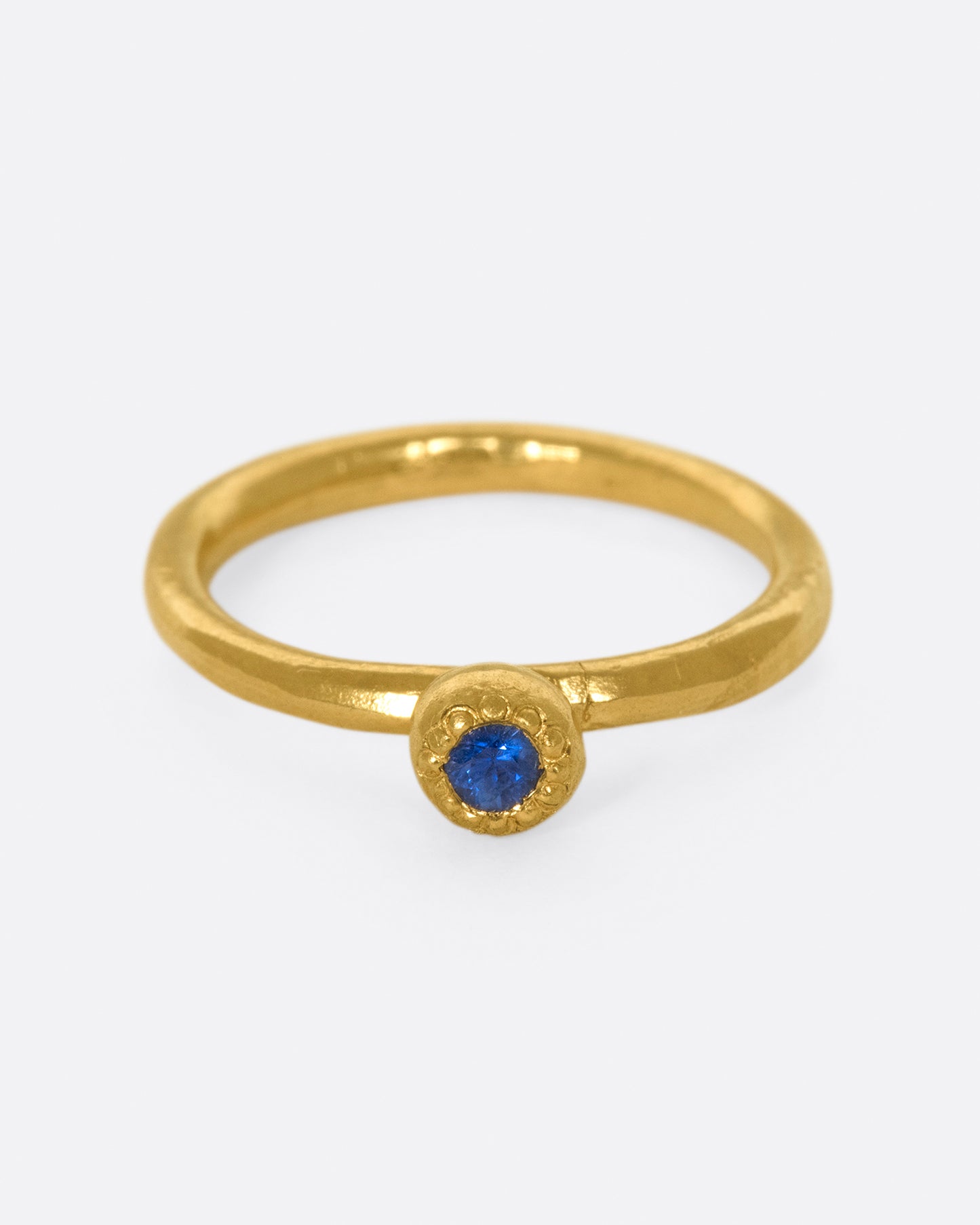 A deep blue sapphire solitaire ring; perfect on its own or stacked with its emerald counterpart.