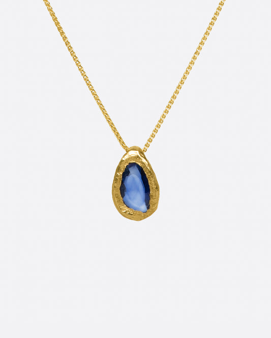 A hand carved bezel pendant containing a deep blue rose cut sapphire, perfect for everyday wear.