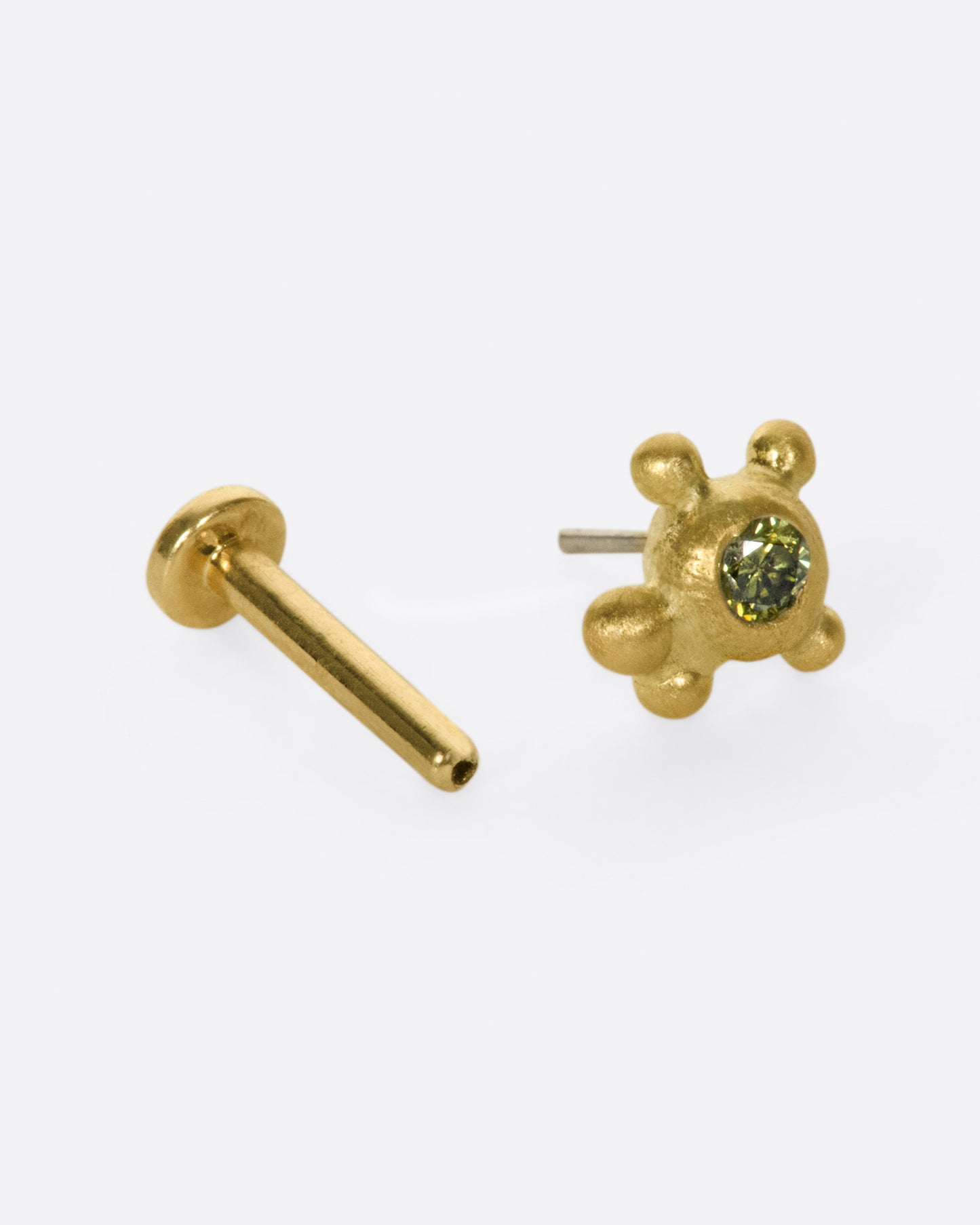No two of these cluster studs is exactly the same; this time with four granules and an olive green diamond.