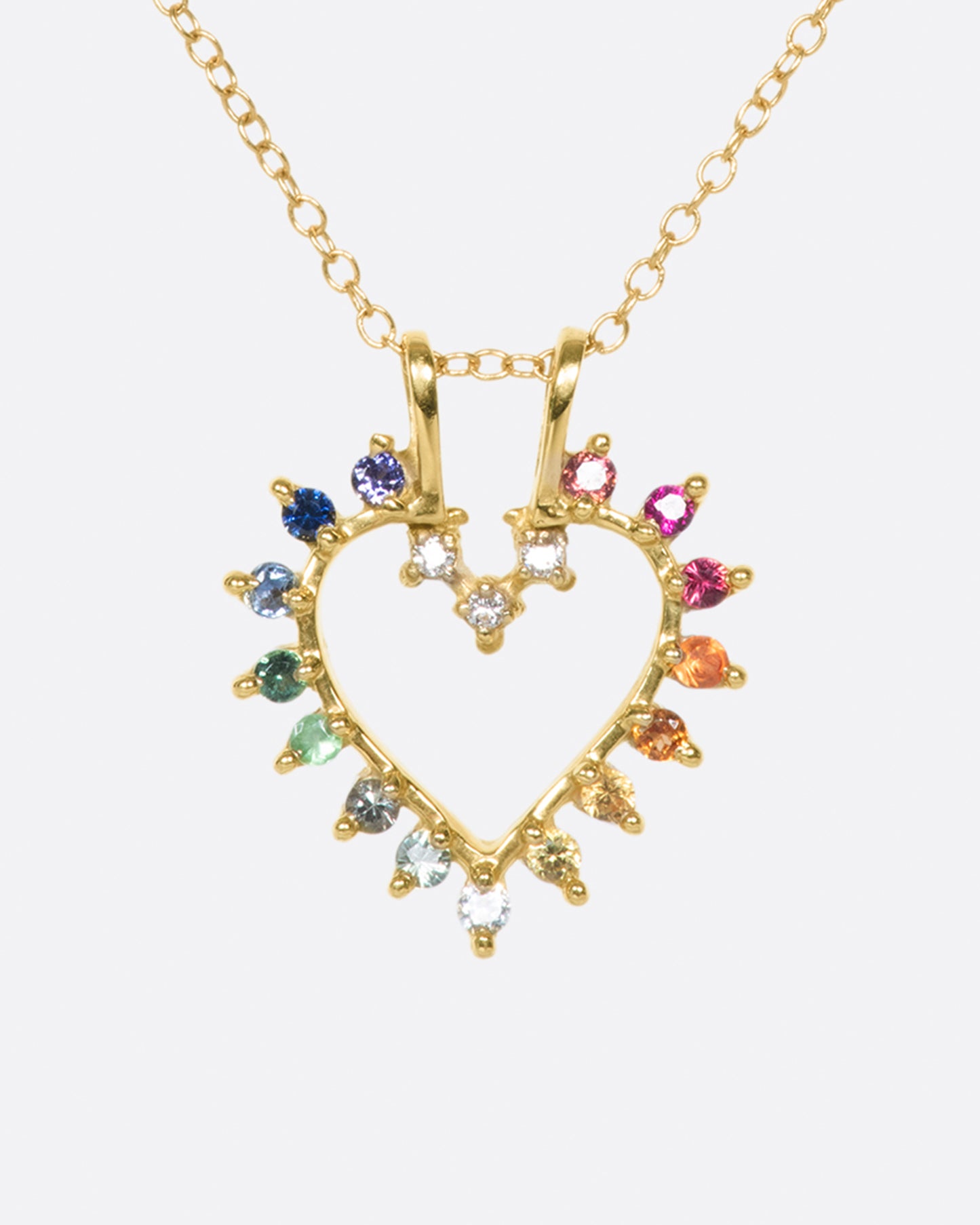 A vintage-inspired heart pendant necklace lined with rainbow sapphires and diamonds.