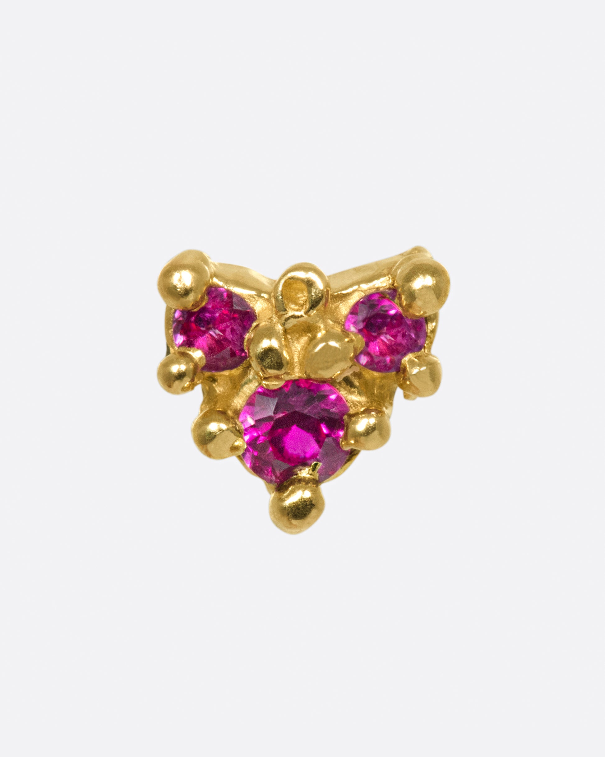 A triangle-like shape, but more organic and dotted with rubies; this piece will add both color and texture to your ear.