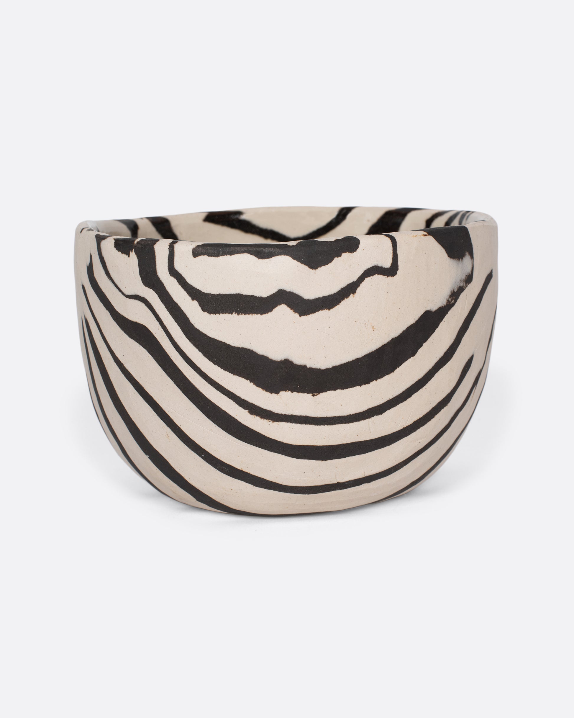 These small-batch ceramic bowls are made with a traditional Japanese Nerikomi technique that creates an intricate, marbled design by layering and compressing clay. Each bowl has a unique, zebra-striped design that feels other-worldly and timeless. Available in small, medium, and large sizes.