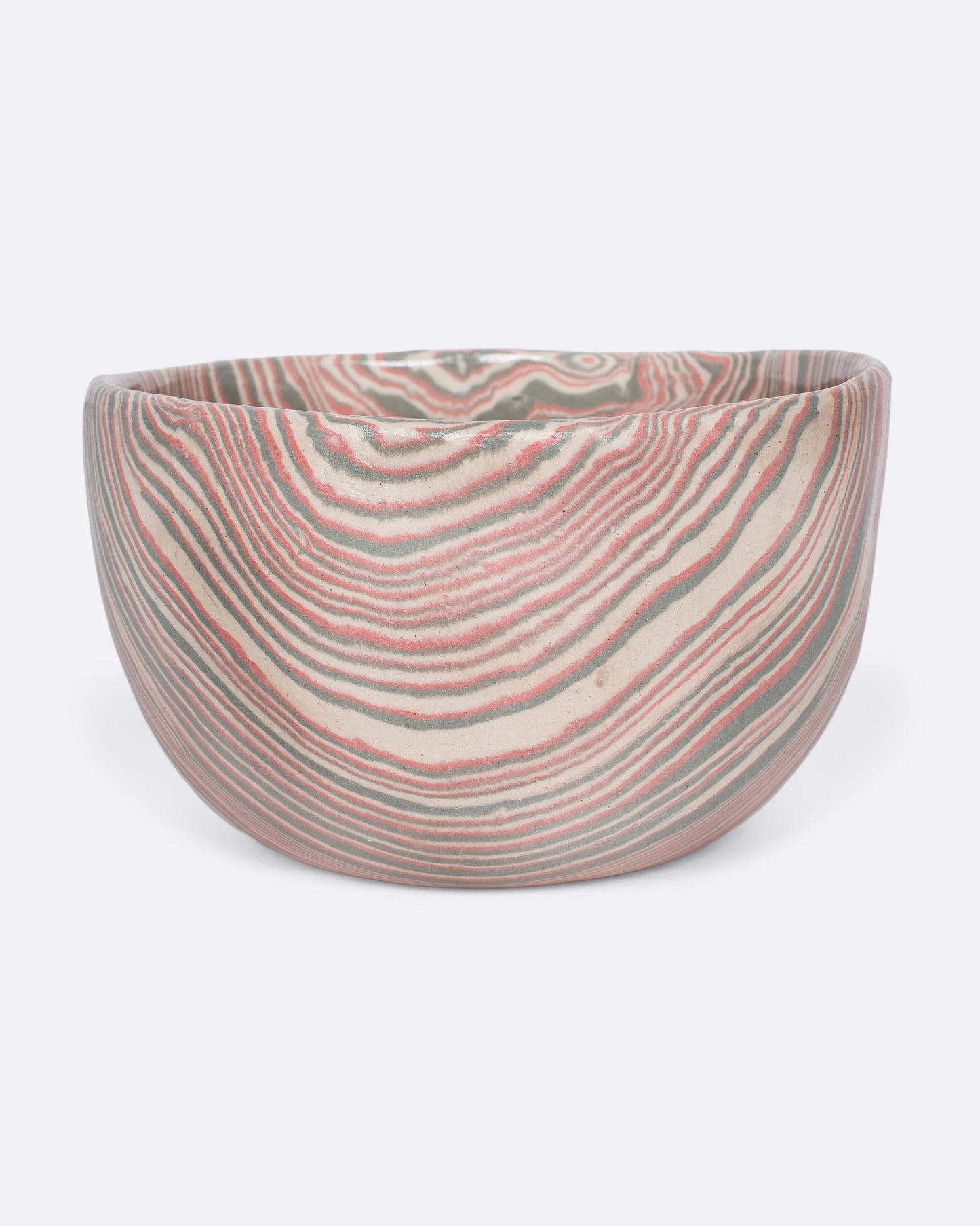 These small-batch ceramic bowls are made with a traditional Japanese nerikomi technique that creates an intricate, marbled design by layering and compressing clay. This timeless style feels plucked from desert sandstone with flowing hues of pink, white, and grey. Available in small, medium, and large sizes.