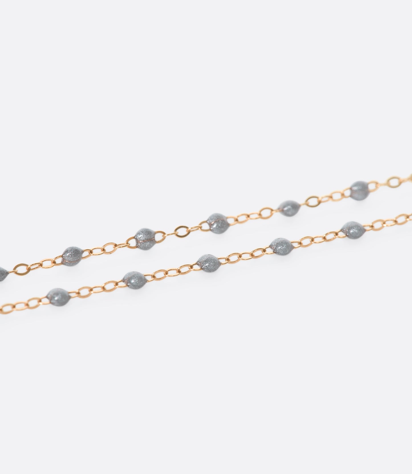 A thin rose gold chain necklace with resin beads. Each necklace is hand dipped in melted resin to create the beaded effect. 