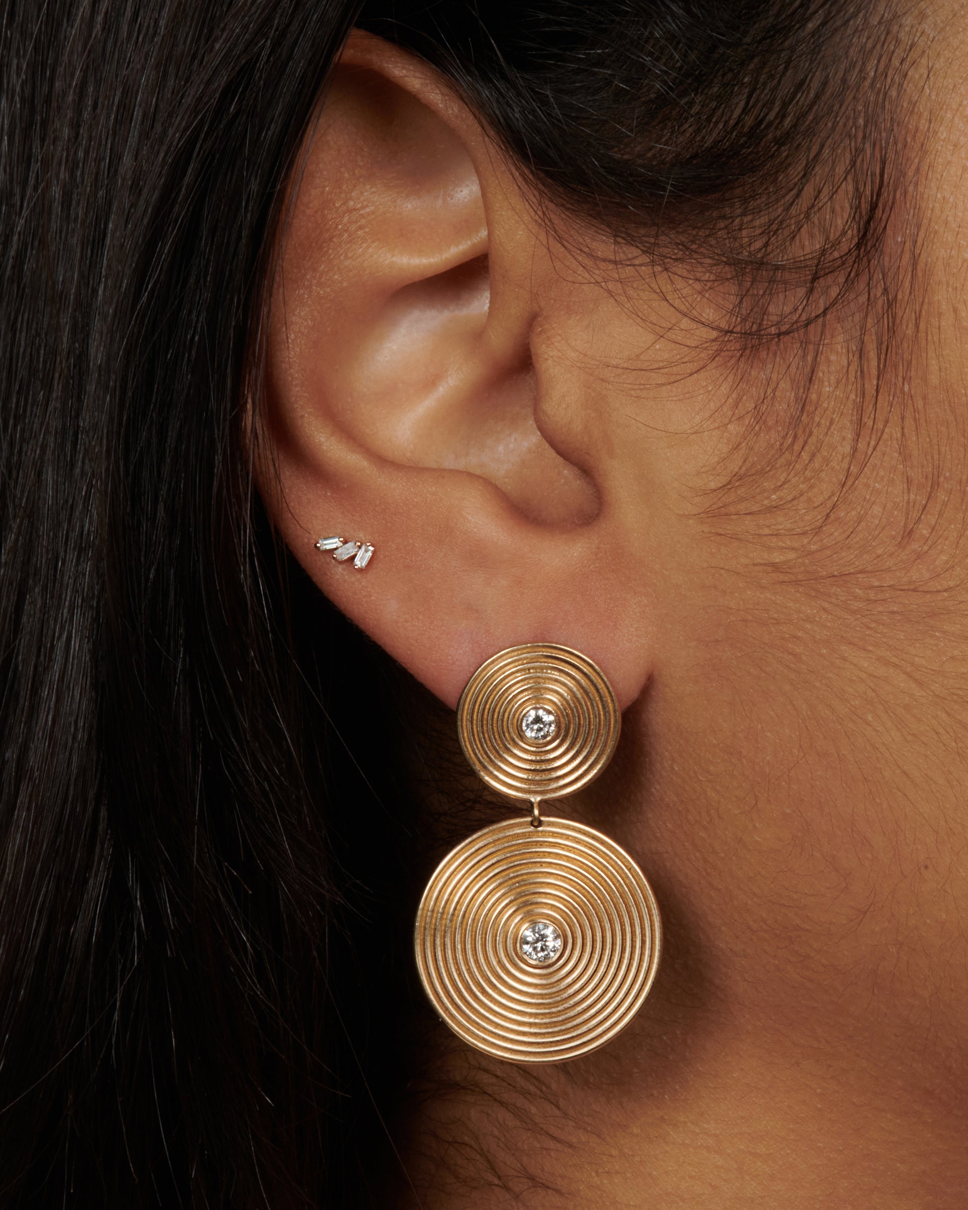 14k gold disc drops, each puntcuated with two white diamonds. The concentric circles are elegant symbols of growth and change.