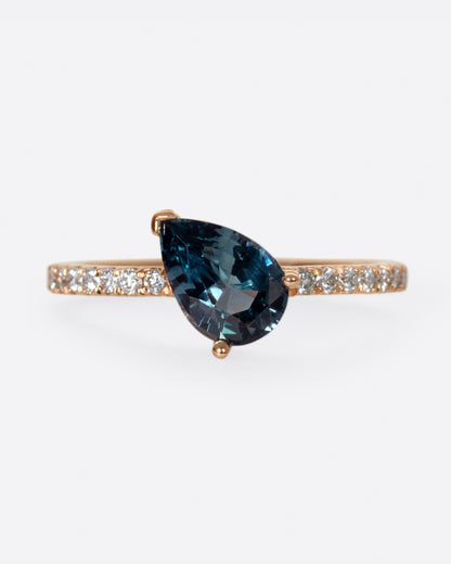 The saturated blue-green sapphire is the star of this ring.